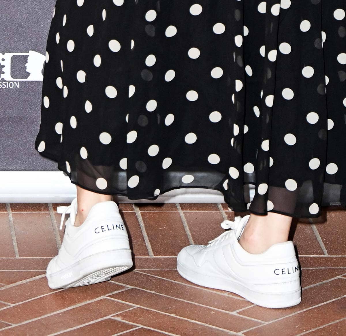 Alexandra Daddario opts for a laid-back look by teaming her polka-dot dress with chunky white Celine sneakers