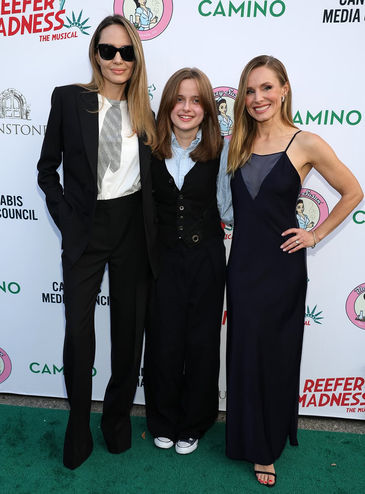 Angelina Jolie and daughter Vivienne Jolie-Pitt pose with Kristen Bell at the opening night performance of Reefer Madness: The Musical at The Whitley Los Angeles