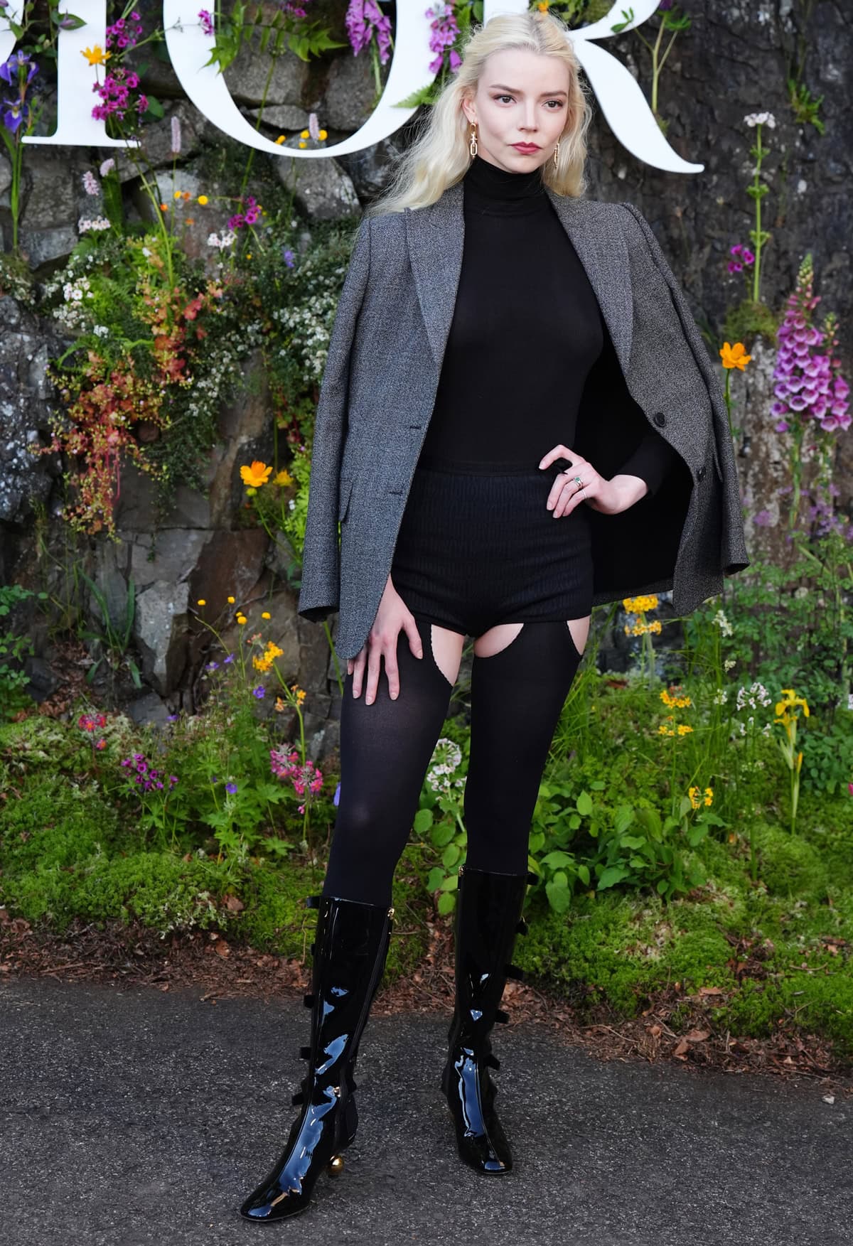 Anya Taylor-Joy at the Dior Cruise 2025 show in a sleek gray blazer and short shorts at Drummond Castle