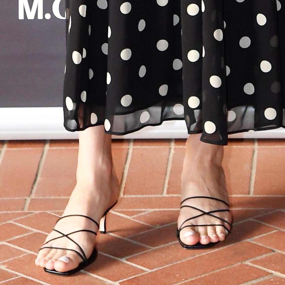 Brie Larson enhances the polka-dot dress's romantic vibe by pairing it with strappy Manolo Blahnik Ninfemu sandals with open toes and kitten heels