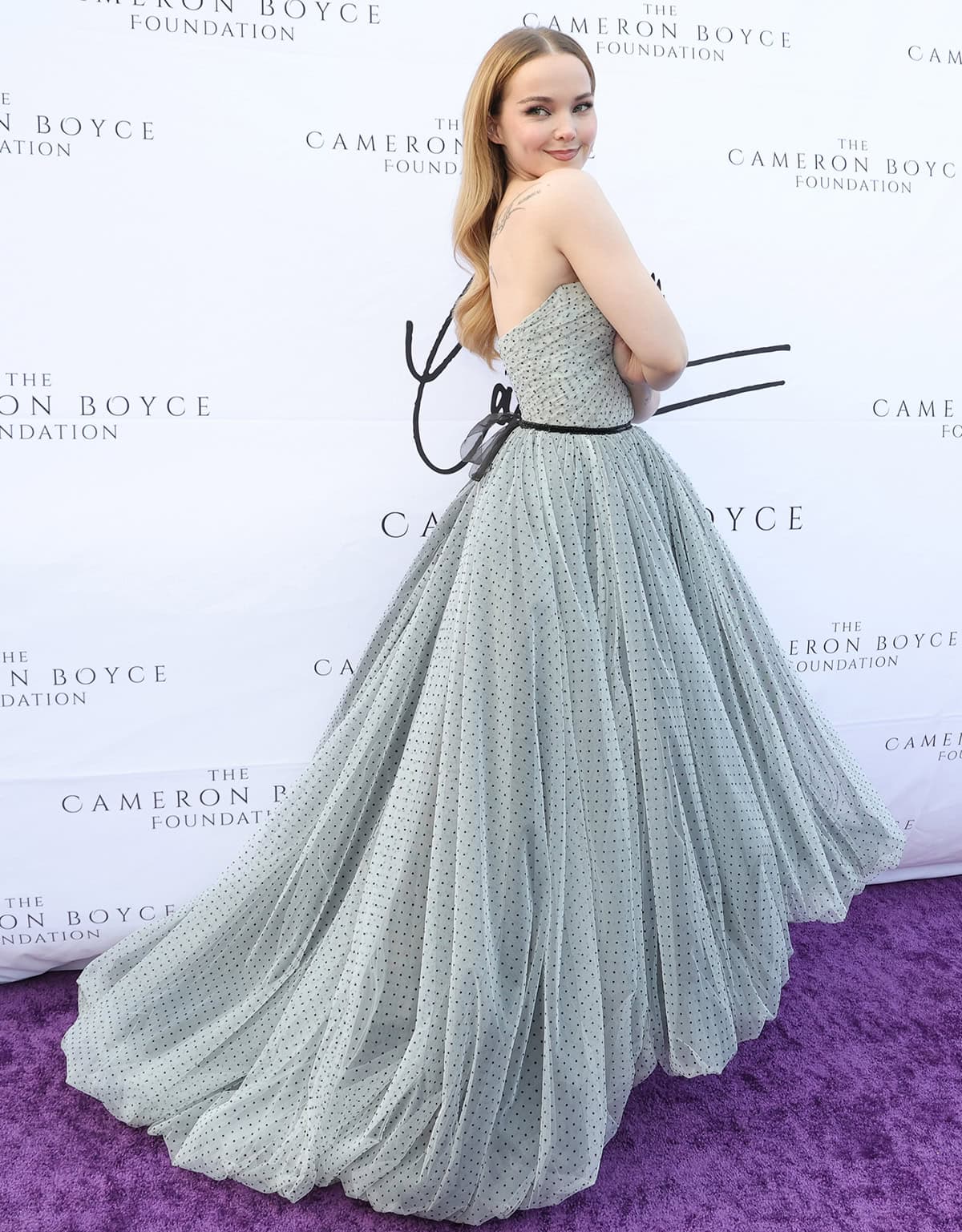 Dove Cameron's Prabal Gurung gown features a strapless sweetheart neckline, a black lace ribbon, and a balloon hem