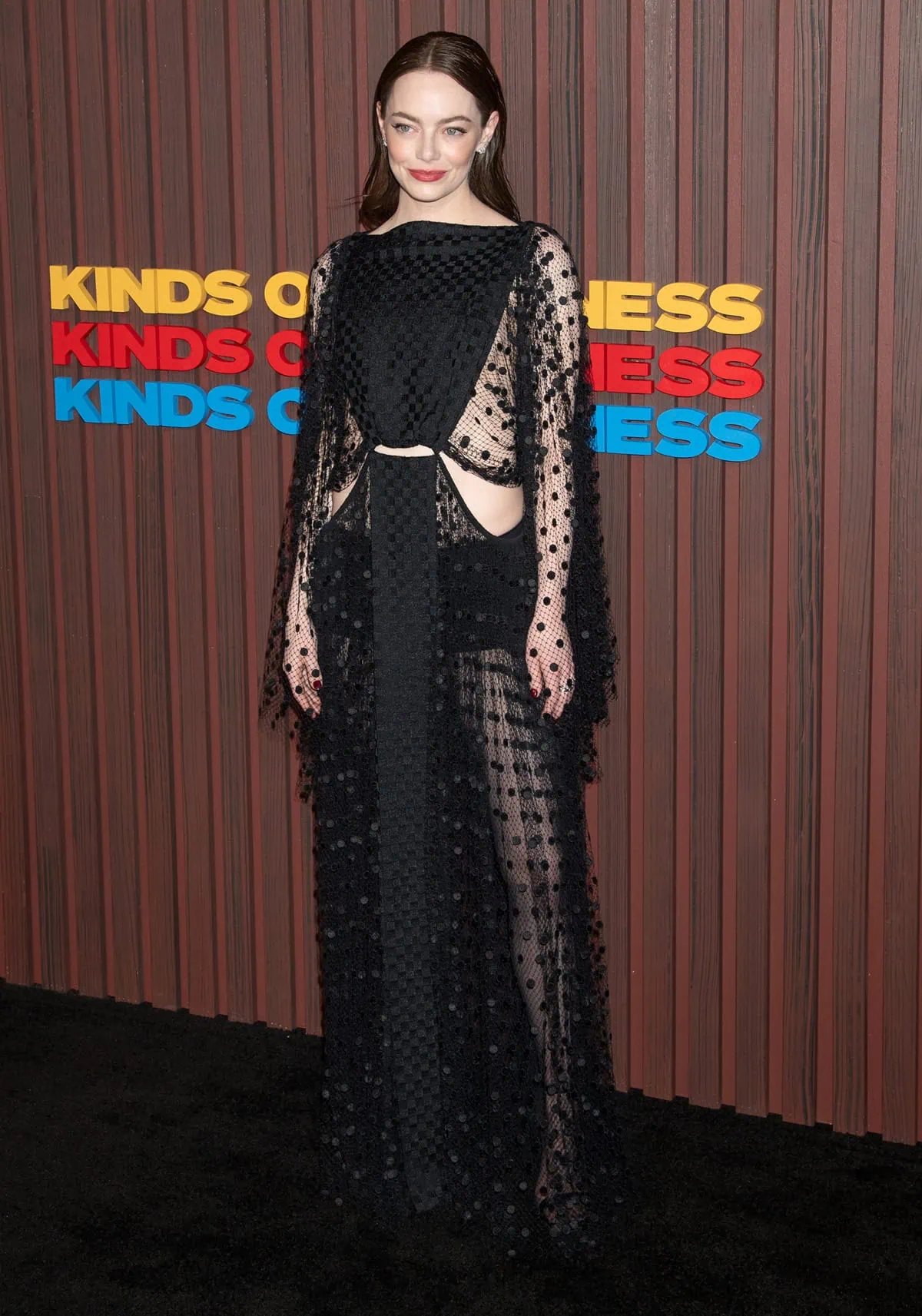 Emma Stone stuns in a sheer Louis Vuitton polka-dot gown, adding a bold and dramatic flair to the red carpet at the New York City premiere of "Kinds of Kindness"
