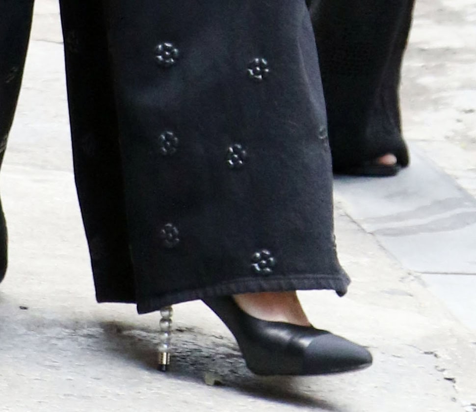 Katie Holmes adds signature Chanel luxury to the laid-back outfit by wearing the house's iconic black pumps with canvas toe caps and pearl heels