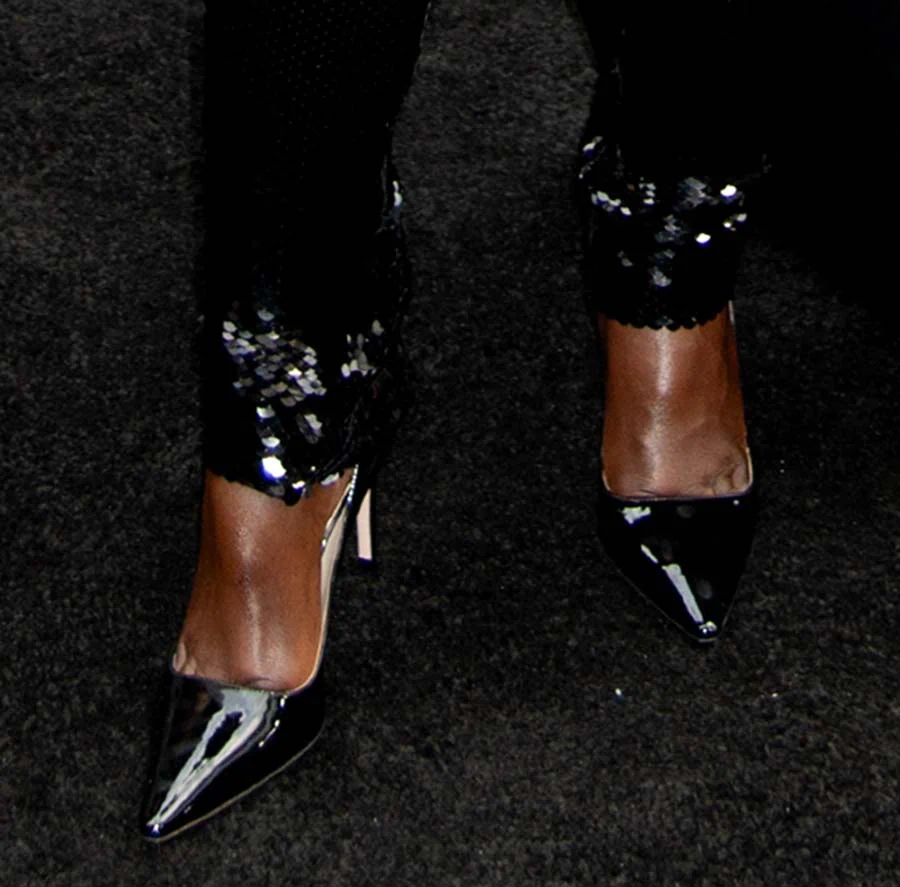 Lupita Nyong'o teams her sparkling sequin catsuit with glossy patent leather pumps