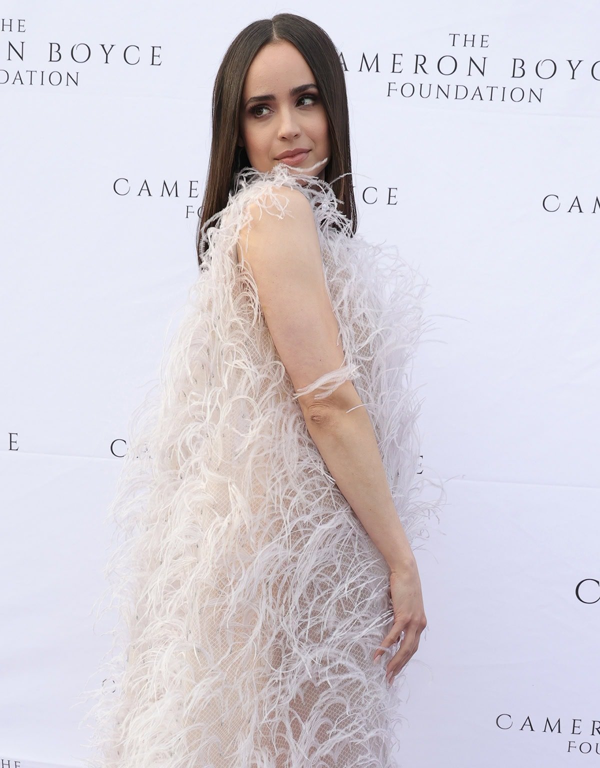 Sofia Carson complements her gown with neutral makeup and straight brunette tresses