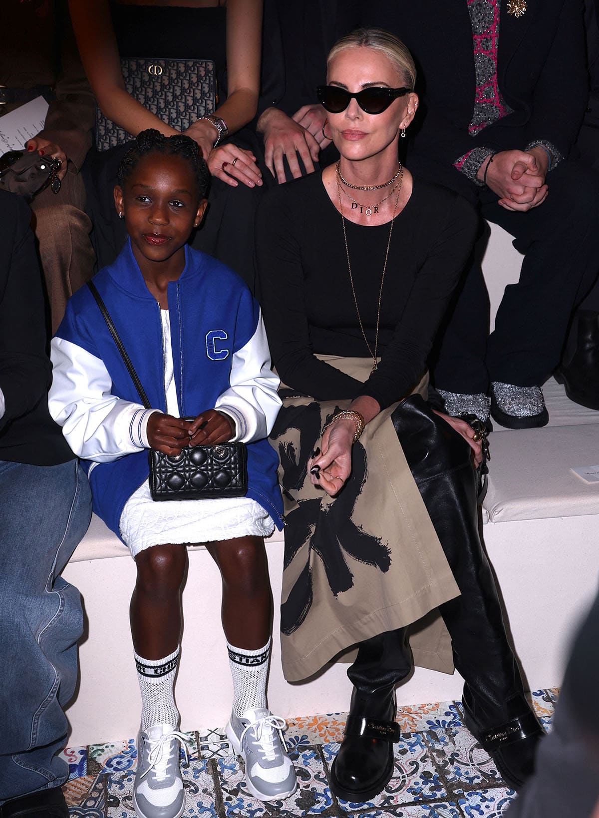 Charlize Theron and her daughter August attend the Christian Dior Fall 2024 fashion show at The Brooklyn Museum in New York City