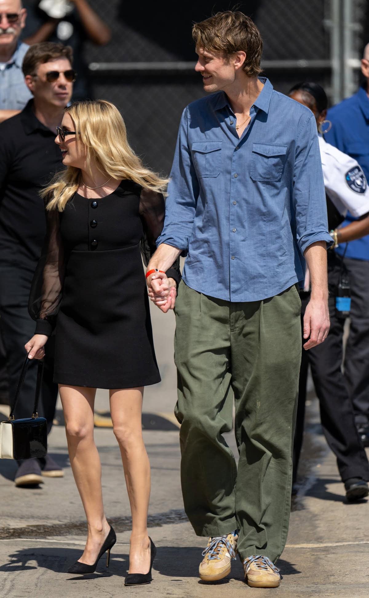 Hand-in-hand with her boyfriend Cody John, Emma Roberts exuded elegance in her monochromatic outfit, perfectly complemented by Manolo Blahnik BB pumps and a black and white Celine bag