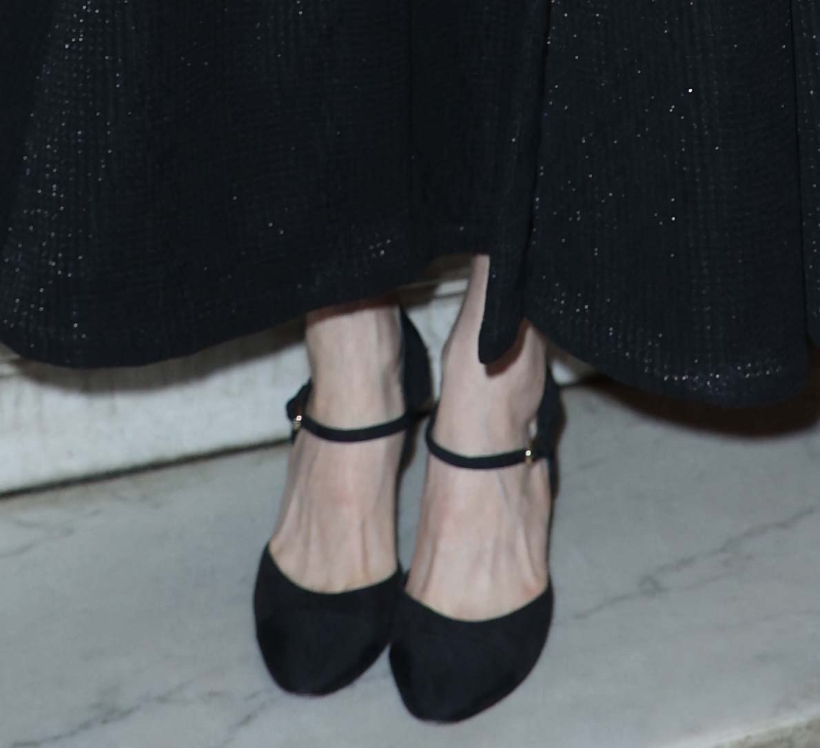 Michelle Williams teams her black A-line dress with black Chanel Mary Jane pumps featuring the house's iconic tonal toe caps