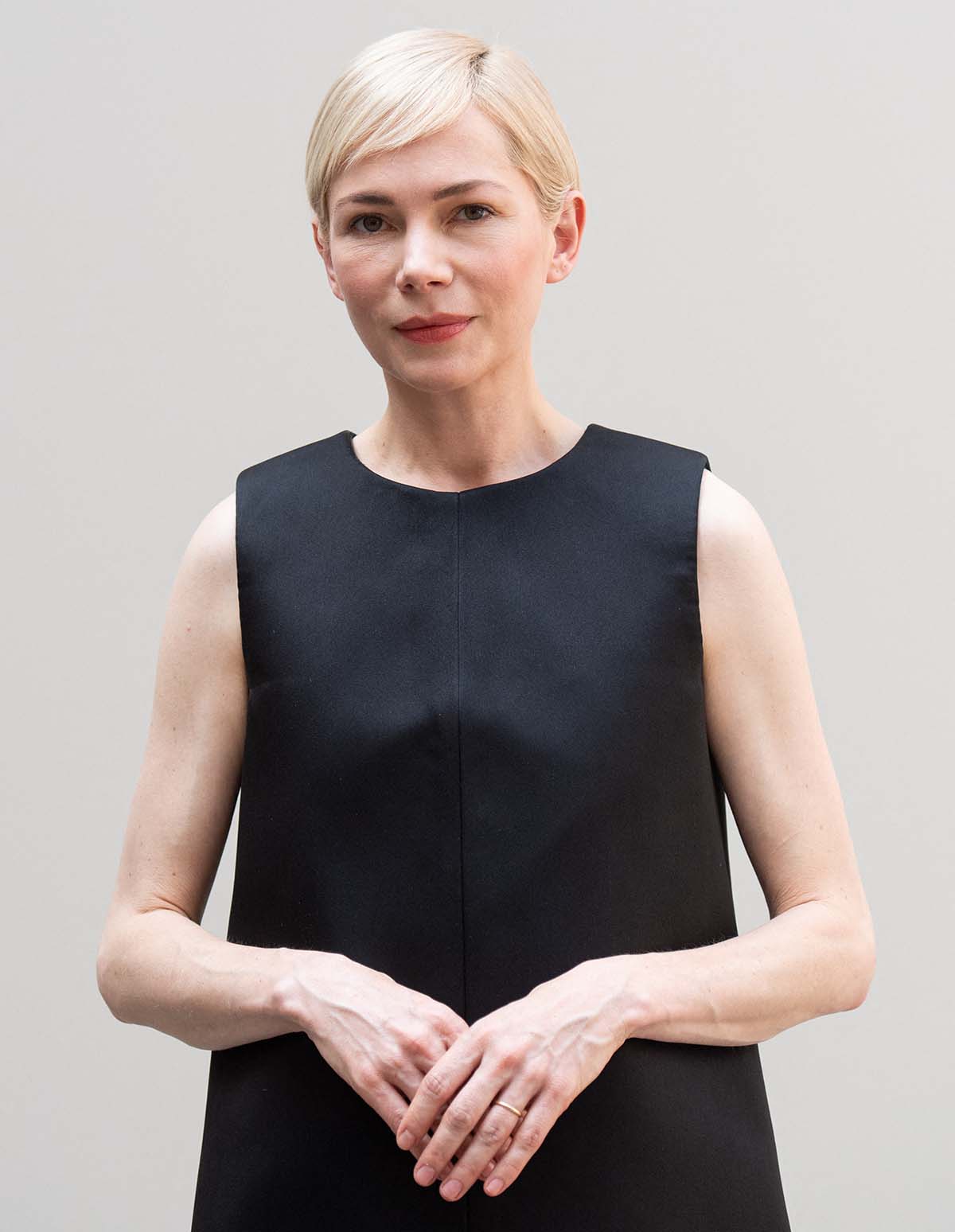Michelle Williams steps out without jewelry, sports her blonde pixie, and wears minimal soft pink makeup