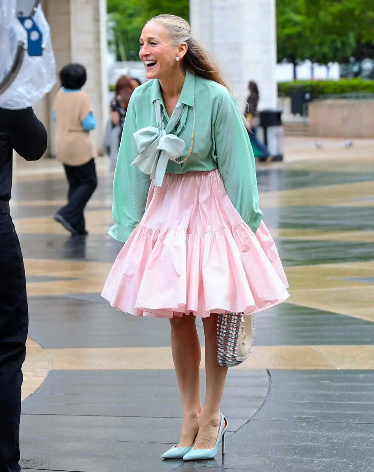 Sarah Jessica Parker exudes freshness and youth in a mint green blouse with a playful pussybow paired with a voluminous pink skirt