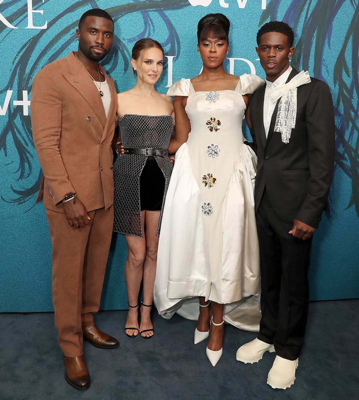 Natalie Portman looks petite in her stylish Dior ensemble, standing next to the taller Y'lan Noel, Moses Ingram, and Josiah Cross