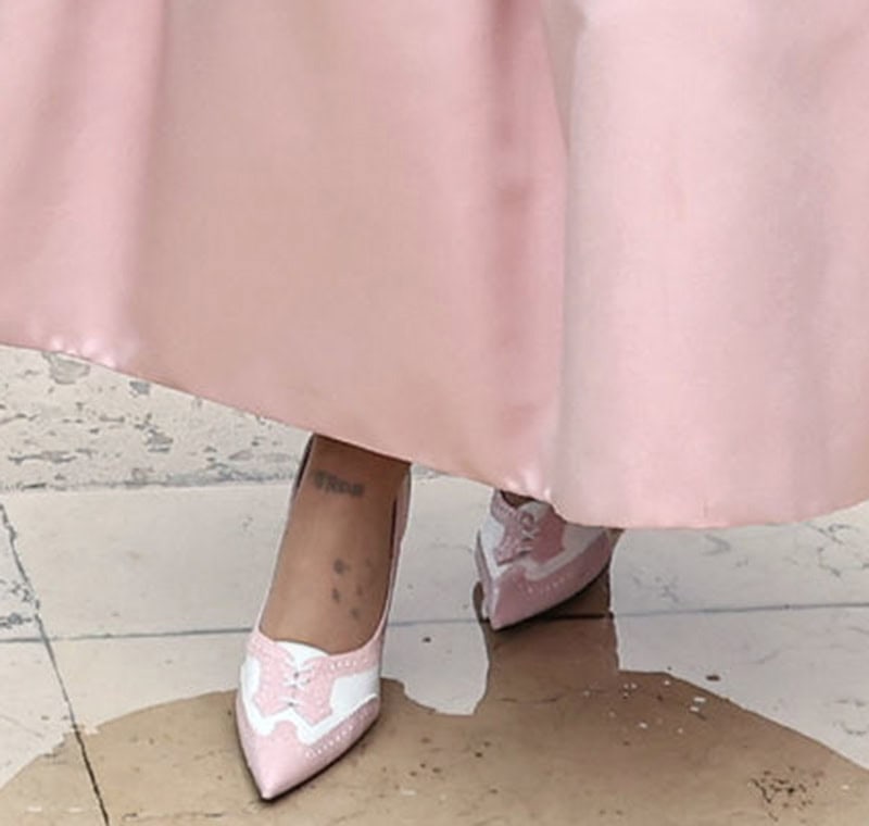 Ariana Grande pairs her pink Thom Browne gown with brogue-style white-and-pink pumps complete with wingtip accents