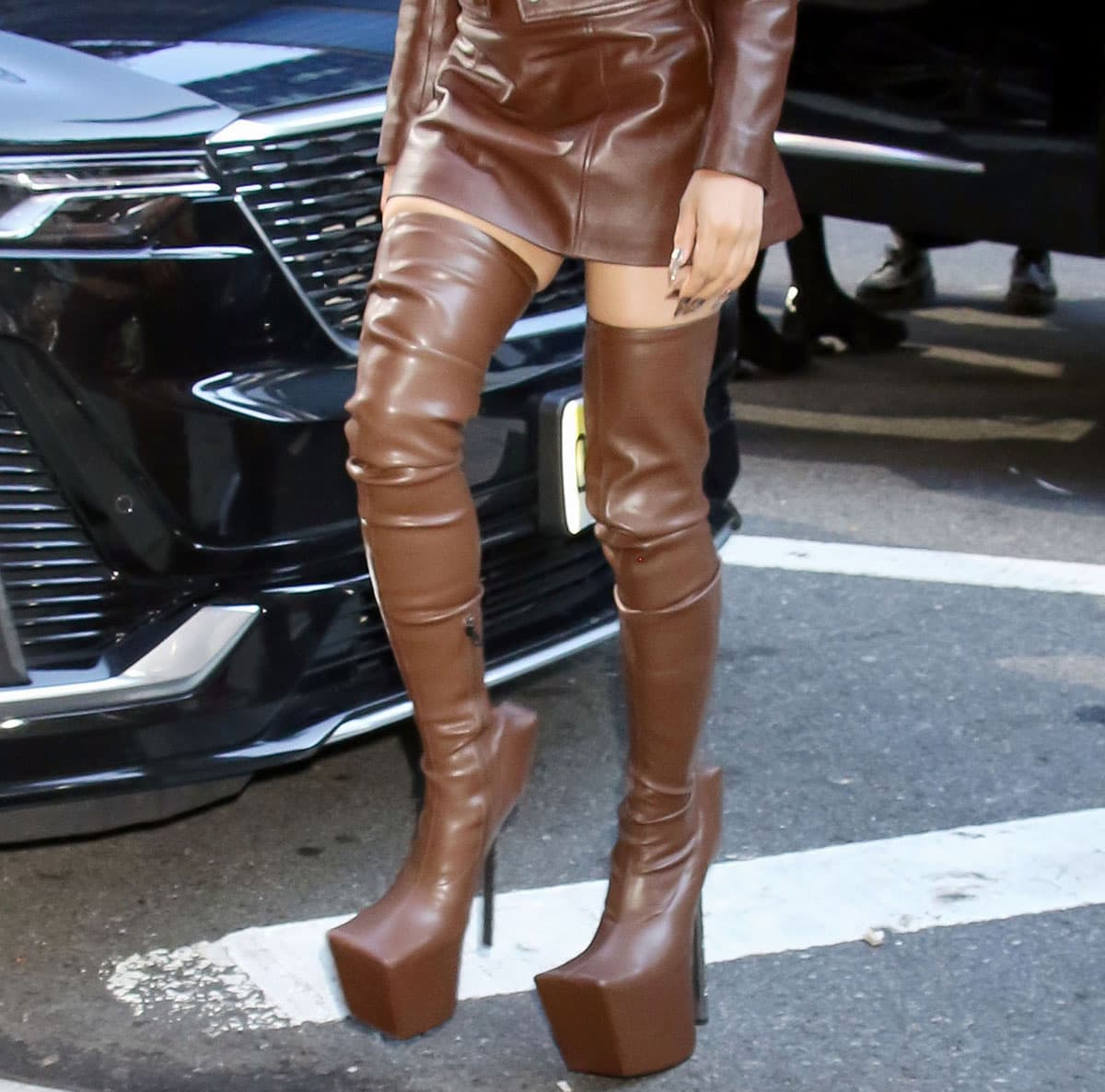 FKA Twigs completes her brown leather monochrome outfit with brown Windowsen platform boots