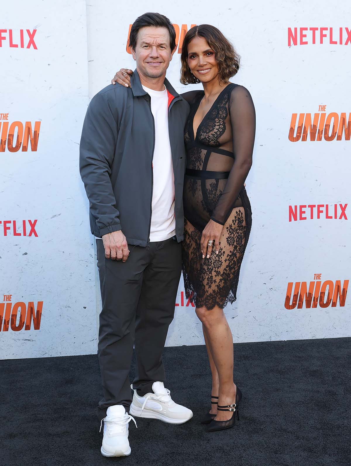 Mark Wahlberg and Halle Berry pose together as they attend the premiere of their first-ever collab project, The Union