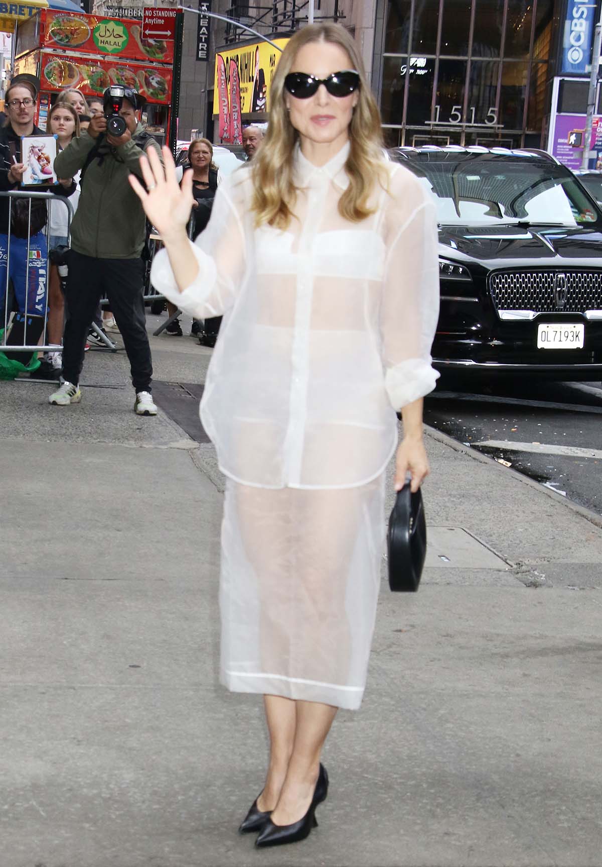 Kristen Bell dares to bare in a white see-through The Frankie Shop shirt and midi skirt outside Good Morning America studios