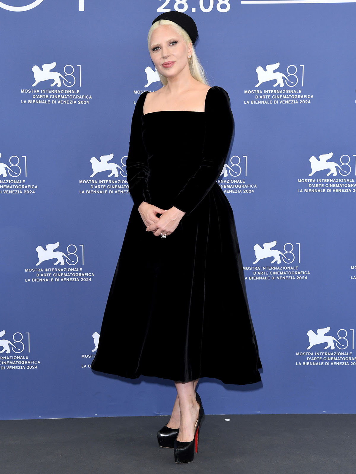 Lady Gaga looks very demure in a custom Dior fit-and-flare A-line velvet dress at the Joker: Folle a Deux Venice Film Festival photocall