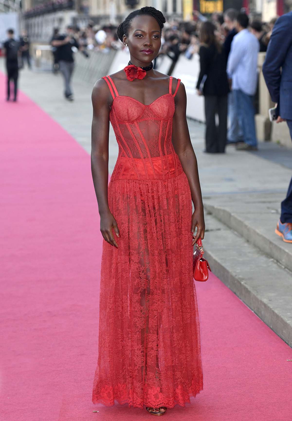 Lupita Nyong'o is bold yet sophisticated in a red see-through lace corset dress by Dolce & Gabbana at The Wild Robot premiere