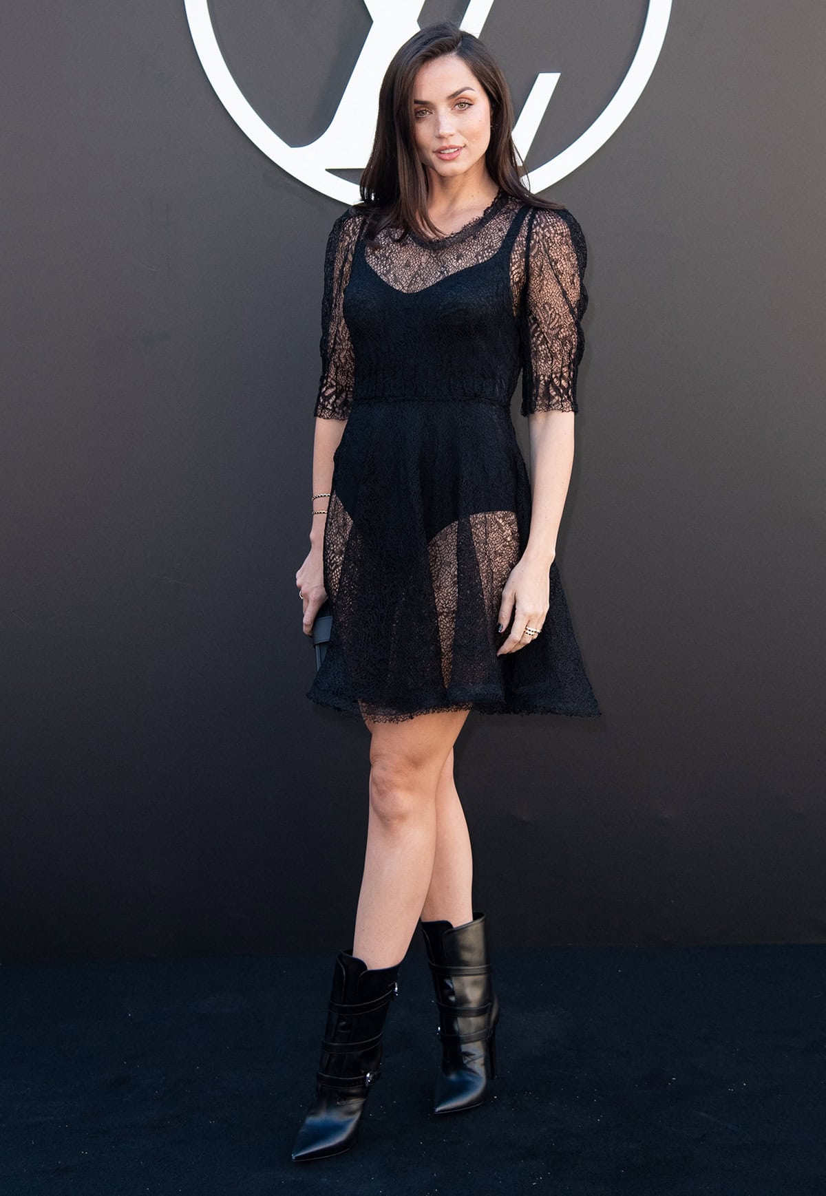 Ana de Armas goes gothic in a sheer lace A-line mini dress with a black bodysuit underneath