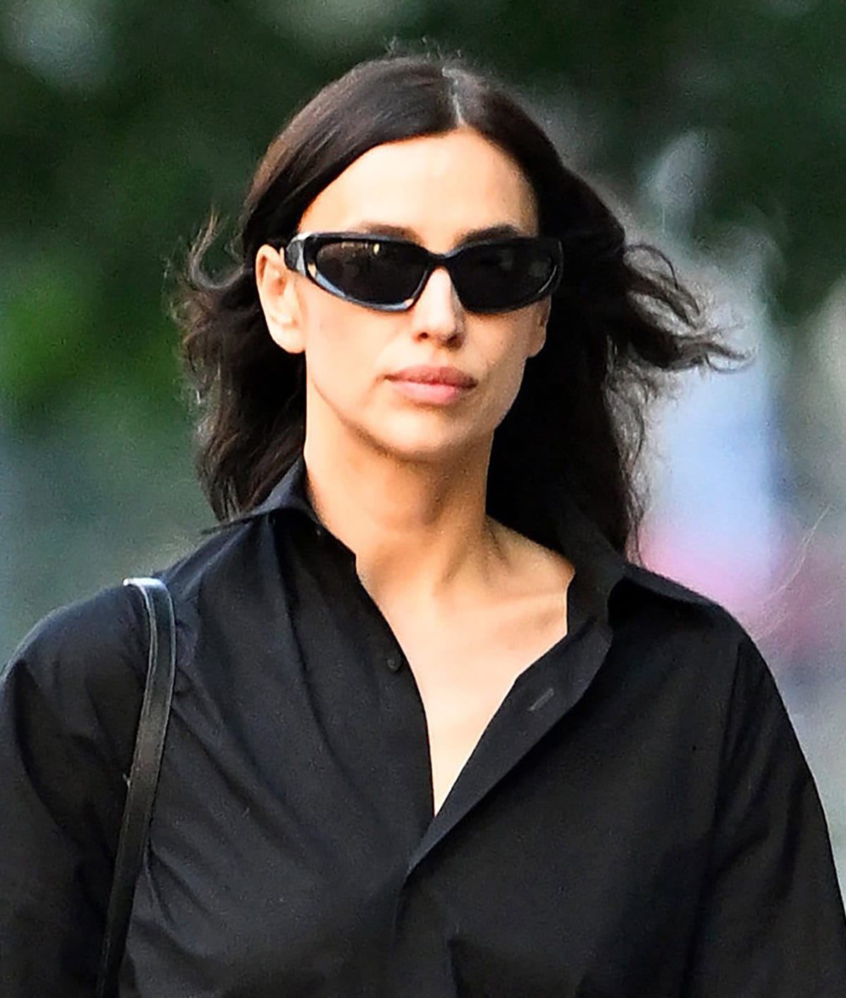 Irina Shayk keeps the rest of her look simple and hides her eyes behind Balenciaga sunnies