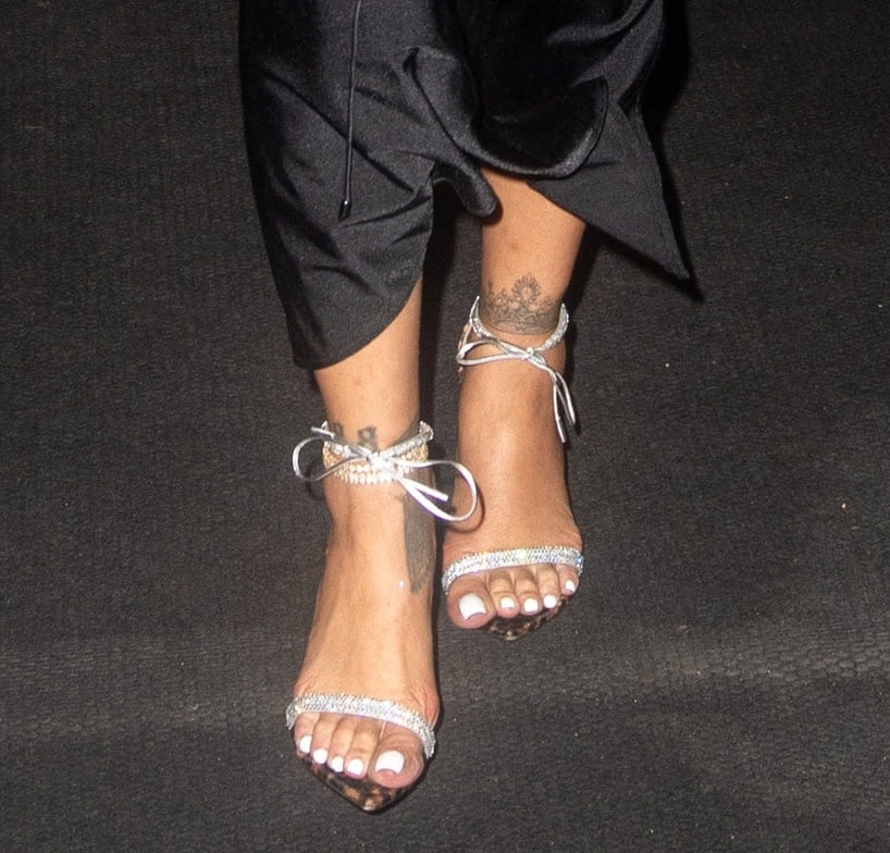 Rihanna teams her long, black dress with Gianvito Rossi leopard-print Montecarlo sandals featuring crystal-encrusted toe straps and ankle tie straps