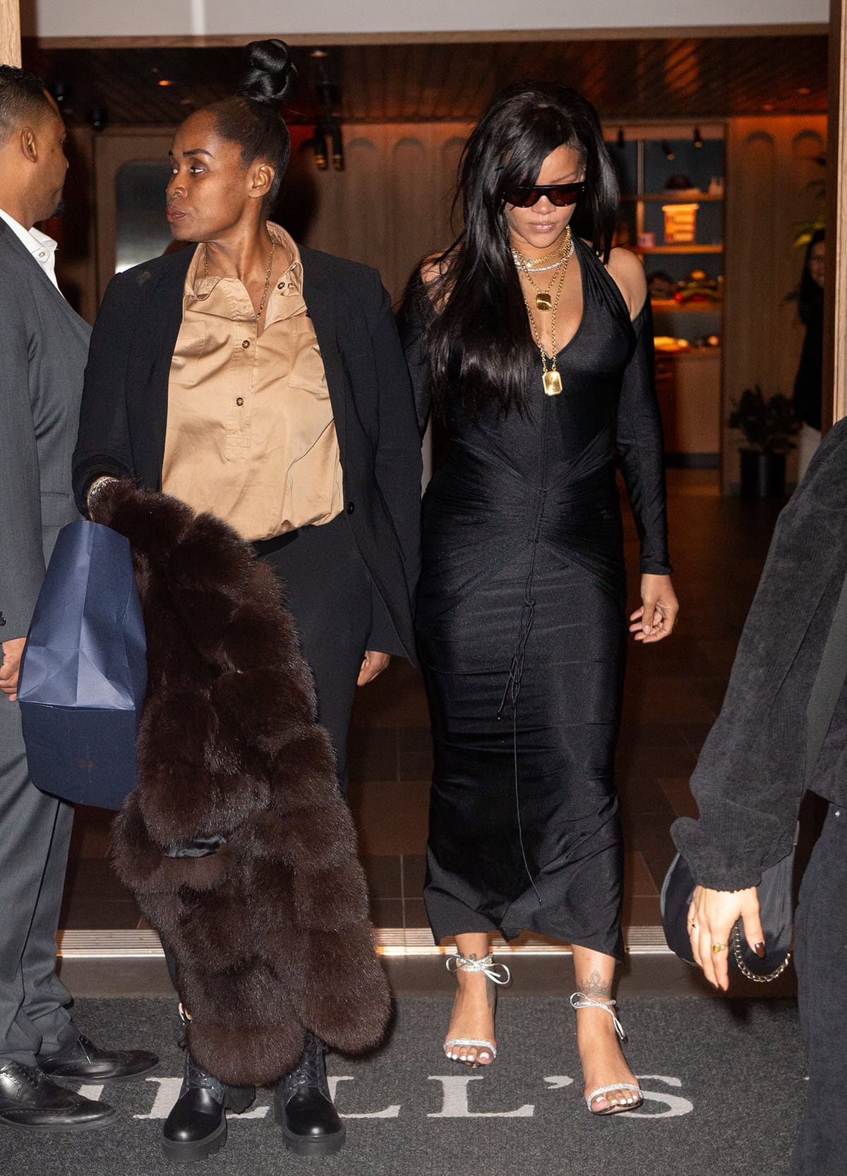 Rihanna's LaQuan Smith dress features a plunging neckline, cutout shoulders, a ruched waist, and long sleeves