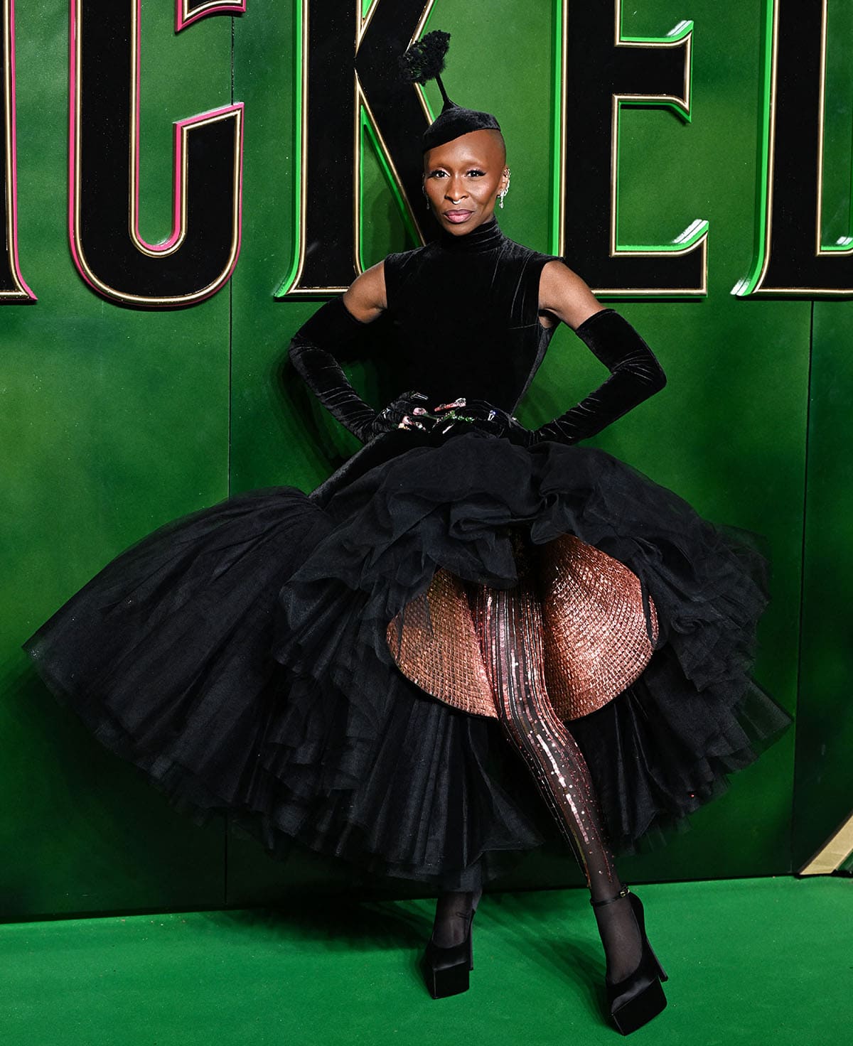 Cynthia Erivo stands out in a black Schiaparelli gown featuring a tulle explosion embellished with square-shaped pink rhinestones and matching tights