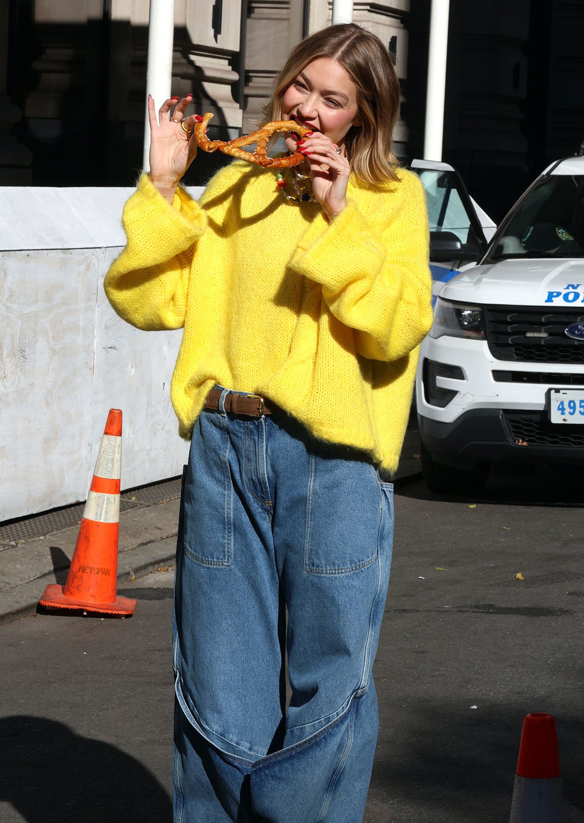 Gigi Hadid is a ray of sunshine in a fall-perfect loose-fitting yellow cable-knit JW Anderson sweater and baggy denim jeans