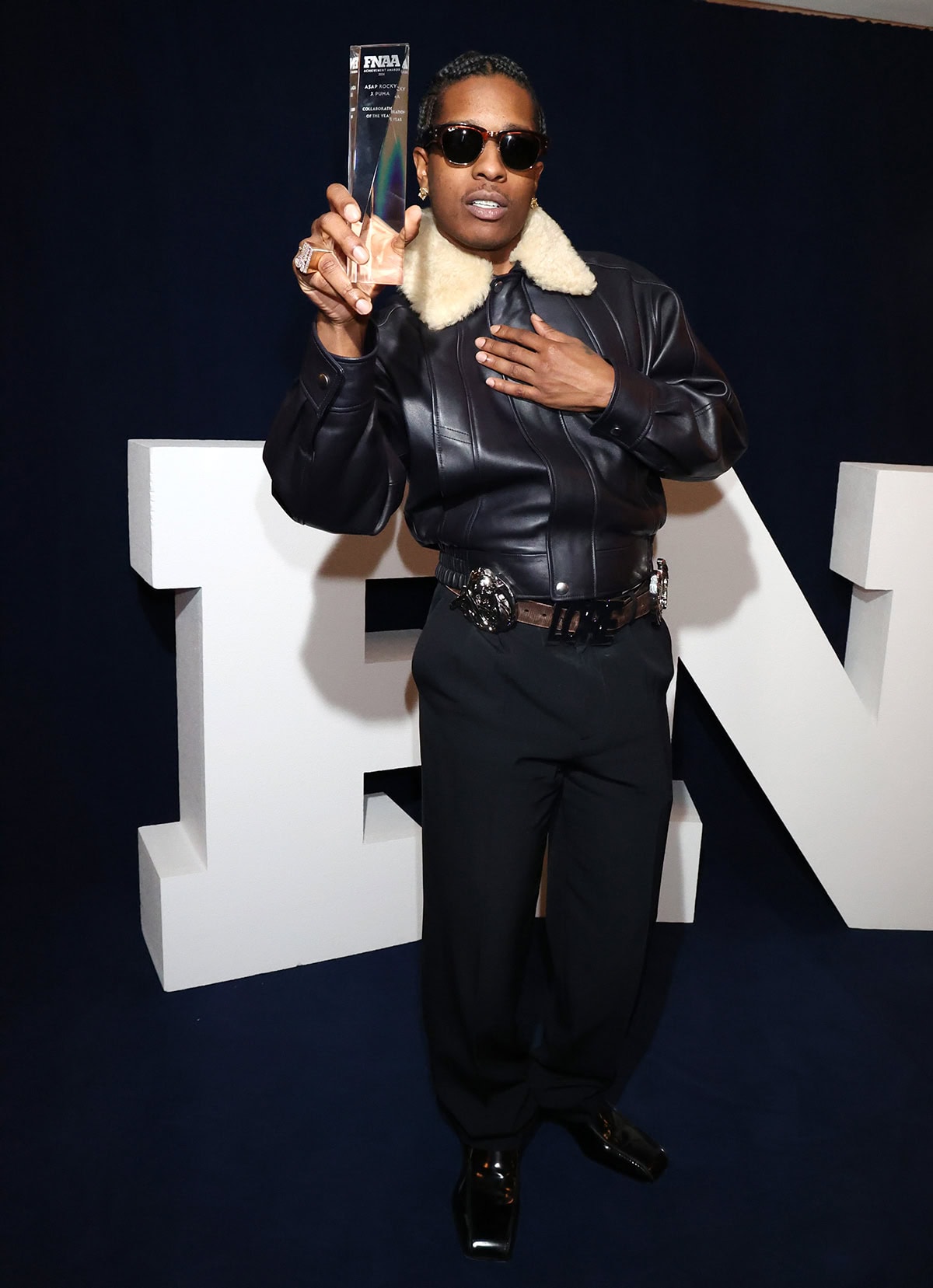 A$AP Rocky, wearing a Bottega Veneta aviator-style bomber jacket and Jim loafers, wins FNAA Collaboration of the Year for his collection with Puma