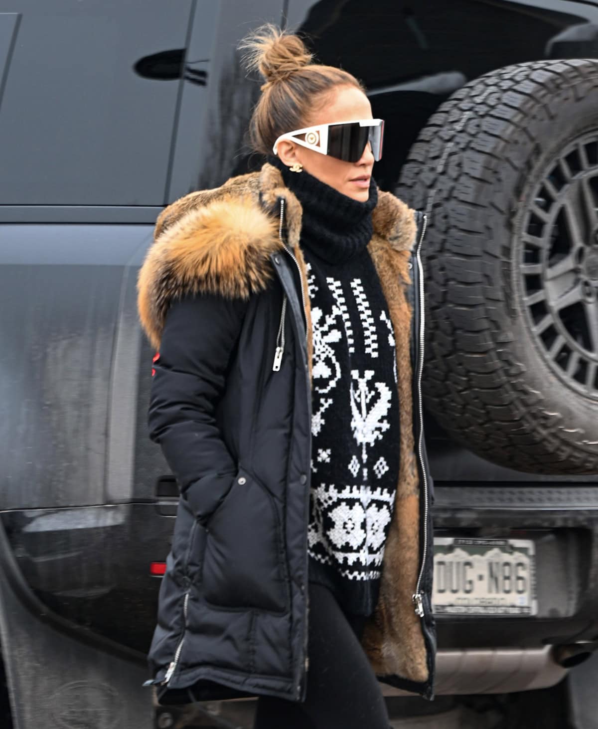 Jennifer Lopez's Nicole Benisti parka jacket features a winterproof, water-repellent mega twill shell, a 90/10 goose-down fill, and a removable dyed raccoon fur trim hood