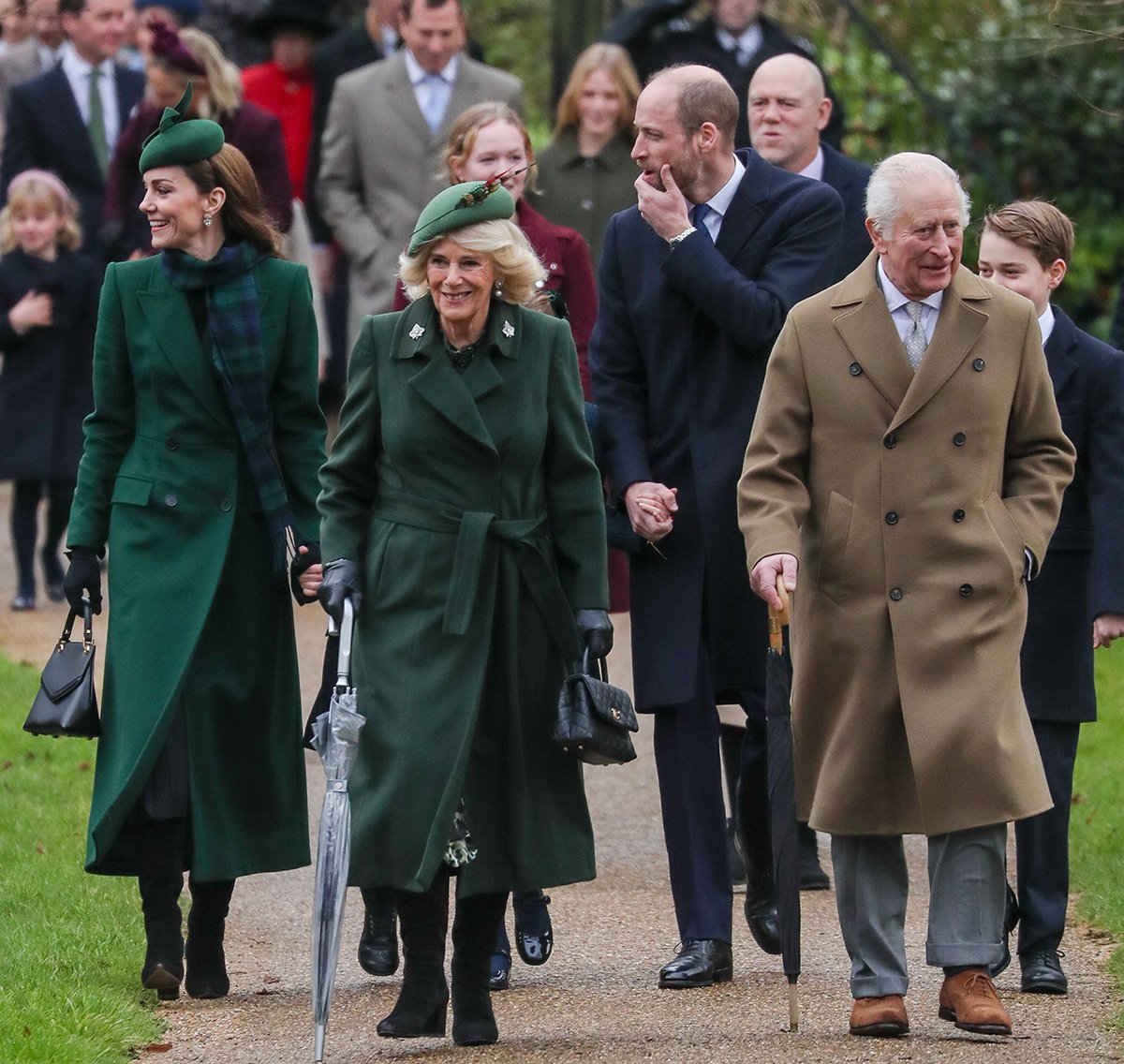 Catherine Princess of Wales, Queen Camilla, and William Prince of Wales coordinate in green and blue while King Charles III wears a brown coat with a light blue shirt and gray pants