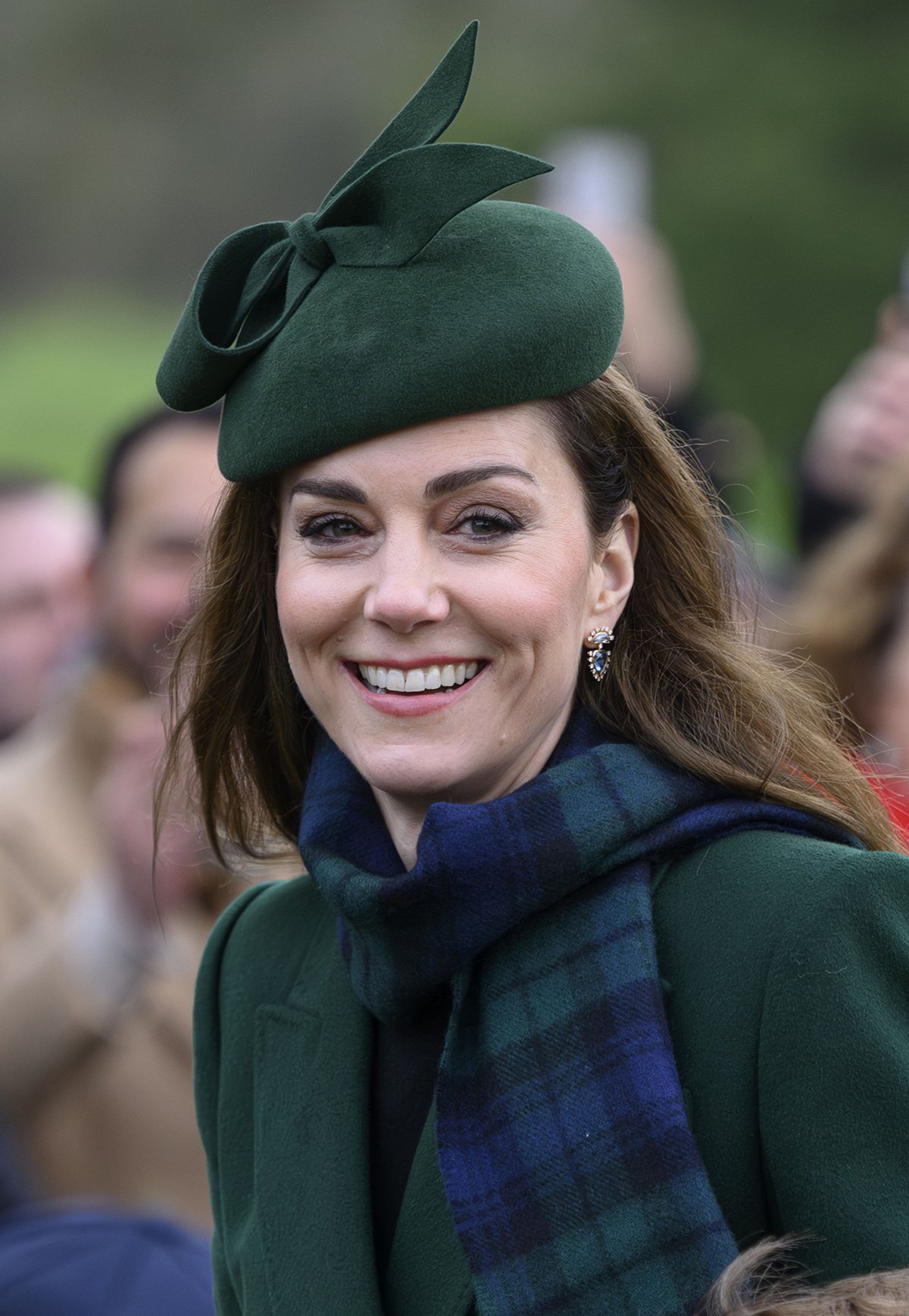 Kate Middleton looks elegant with her Gina Foster fascinator, tartan scarf, and Robinson Pelham Daystar Blue Topaz earrings