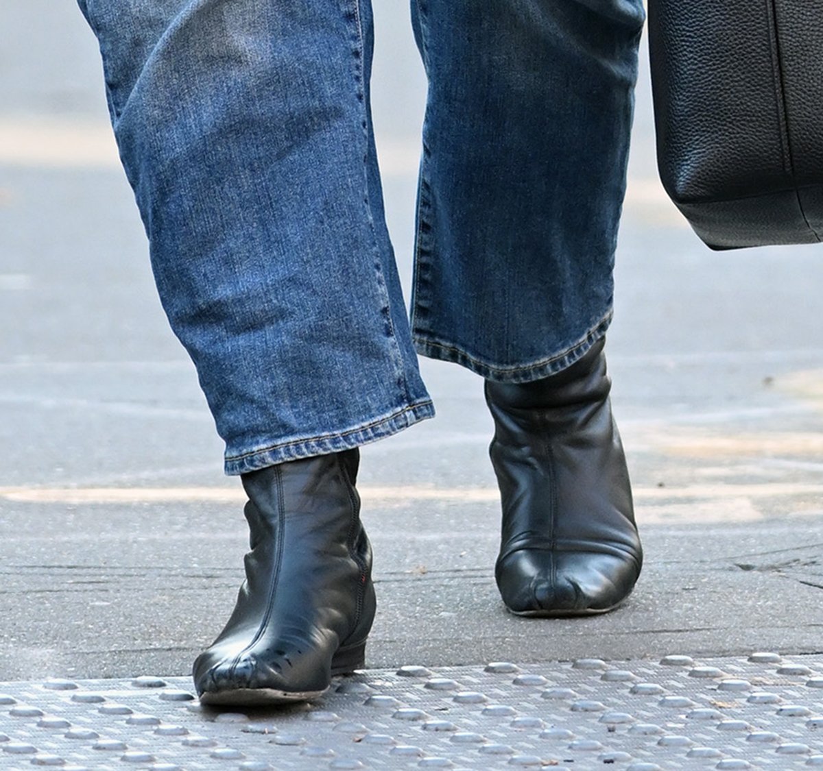 Katie Holmes teams her jacket and jeans combo with black leather square-toe boots