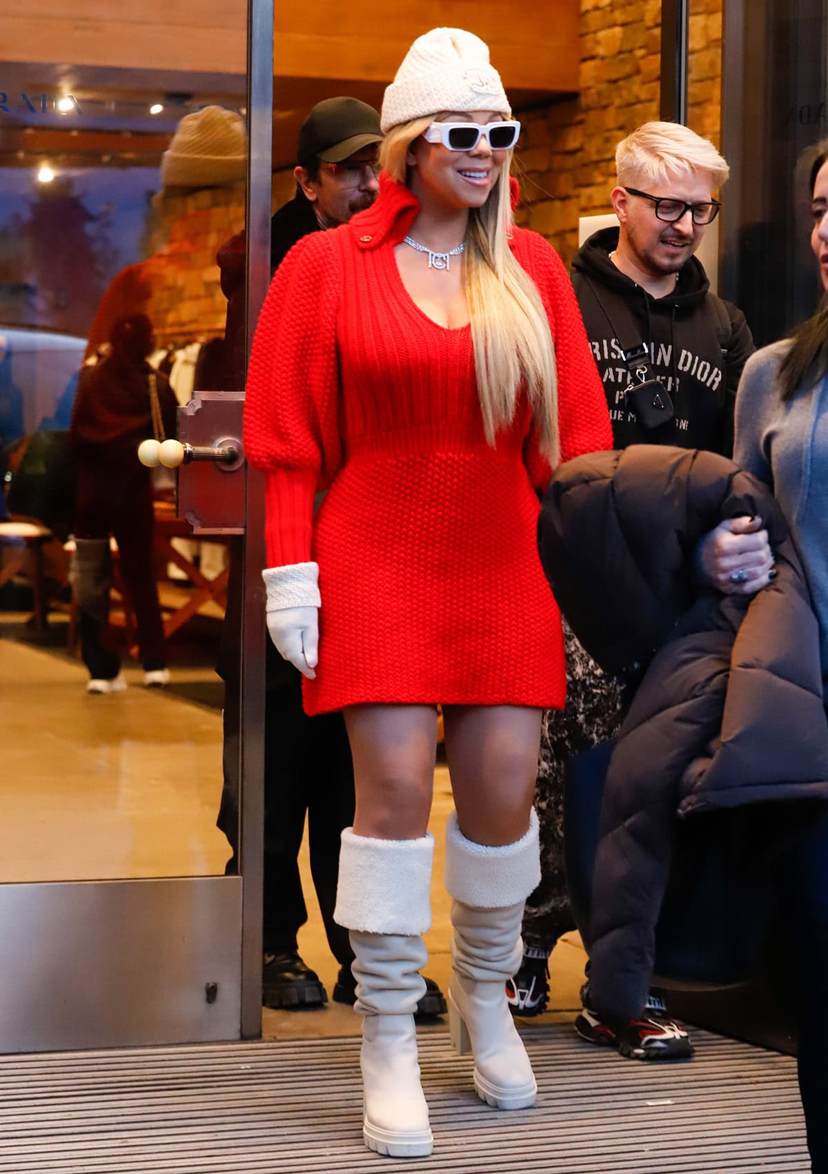 Mariah Carey brings the holiday cheers to Aspen in a red Gucci sweater dress and white Giuseppe Zanotti boots