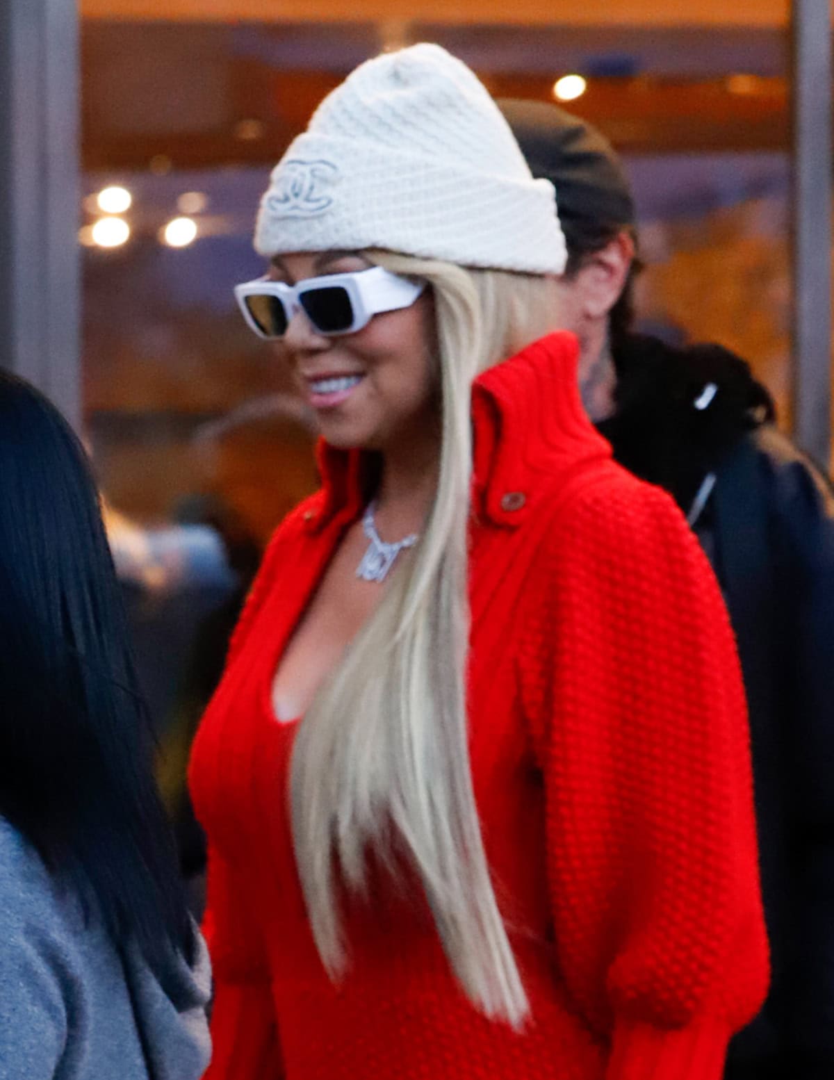 Mariah Carey completes her chic winter look with a Chanel beanie, matching gloves, and white sunglasses