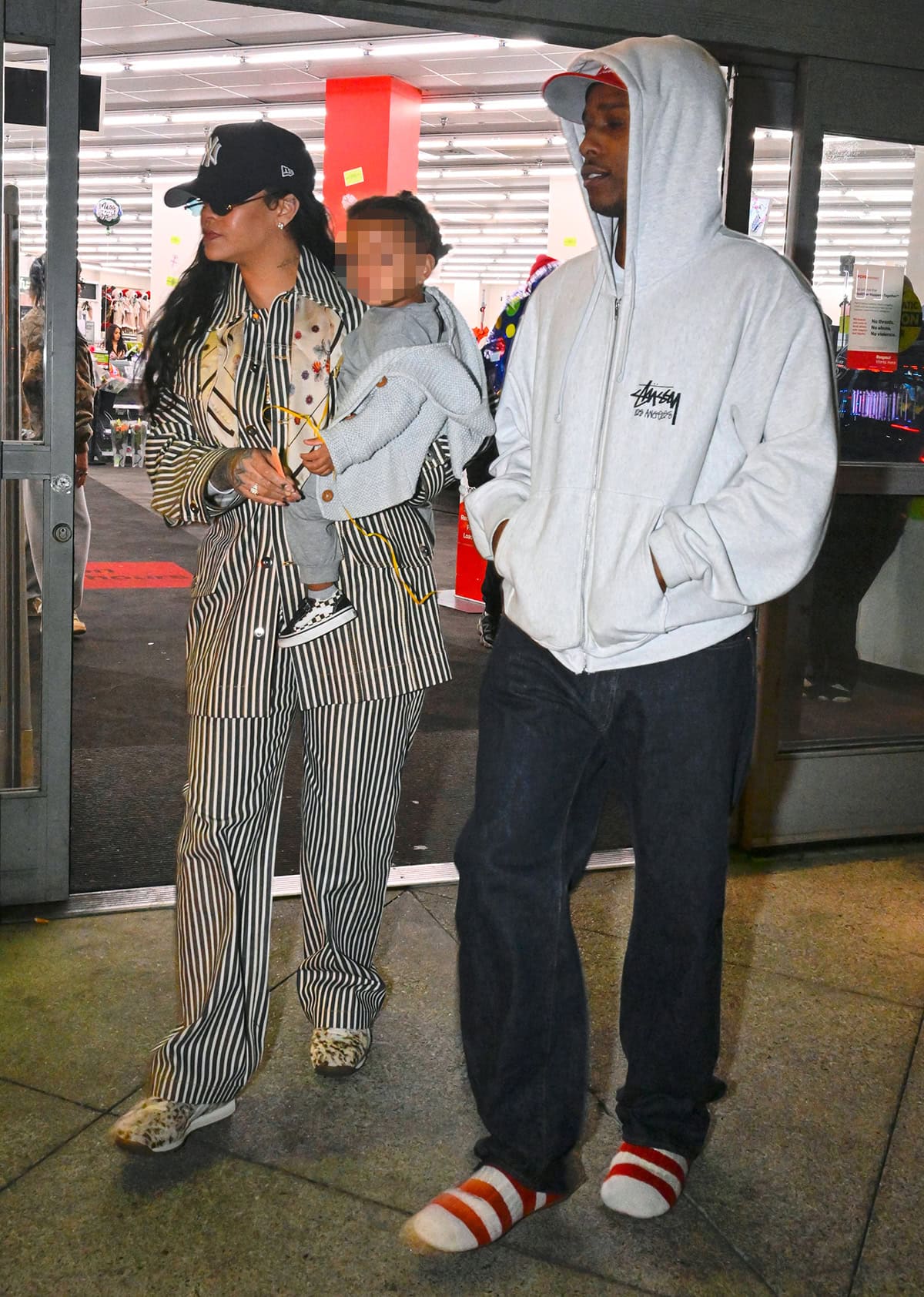 Rihanna steps out with her son Riot and baby daddy A$AP Rocky in a black-and-white striped jacket and pants set by Bottega Veneta