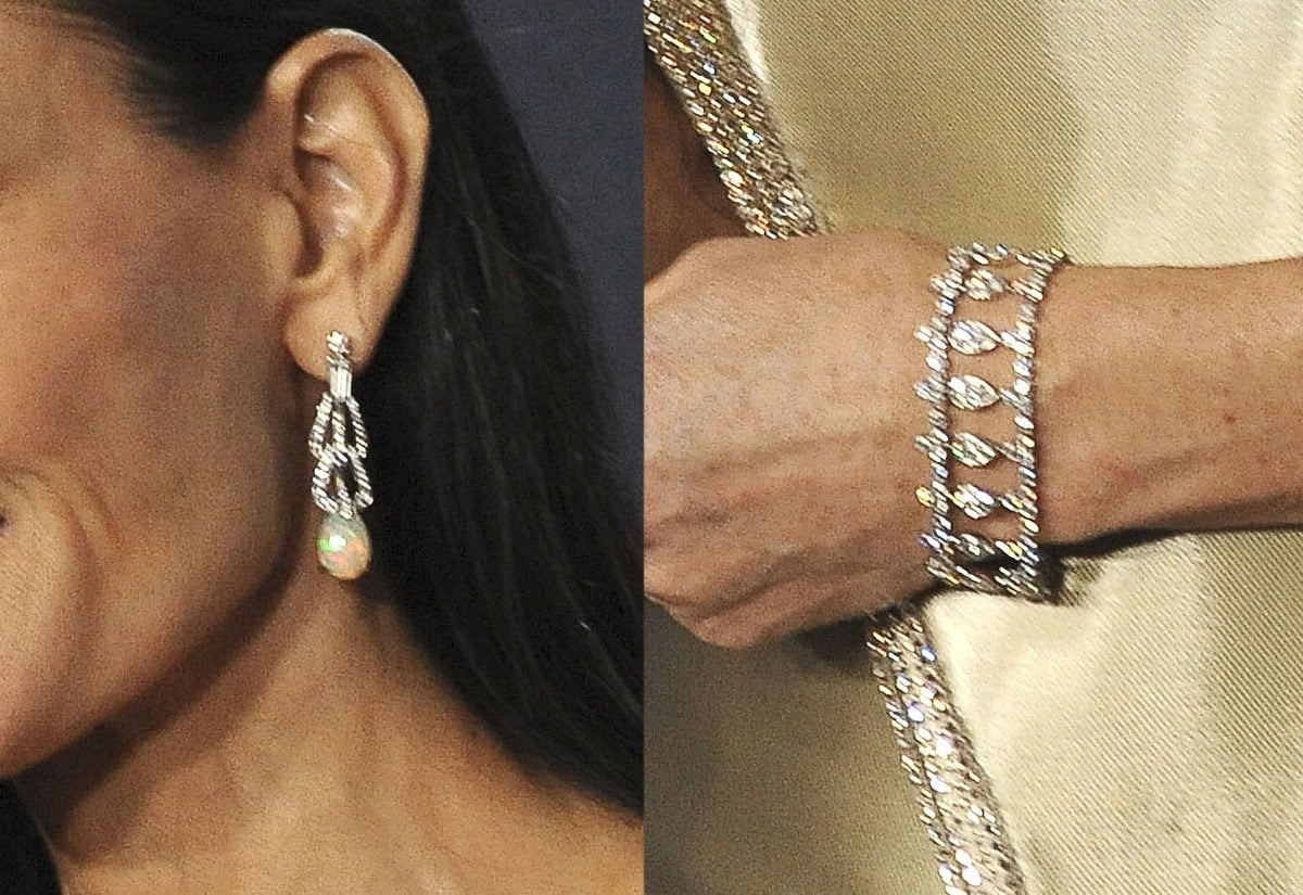 Demi Moore teams her stunning gown with Cartier jewelry, including a pair of dangling earrings and a bracelet