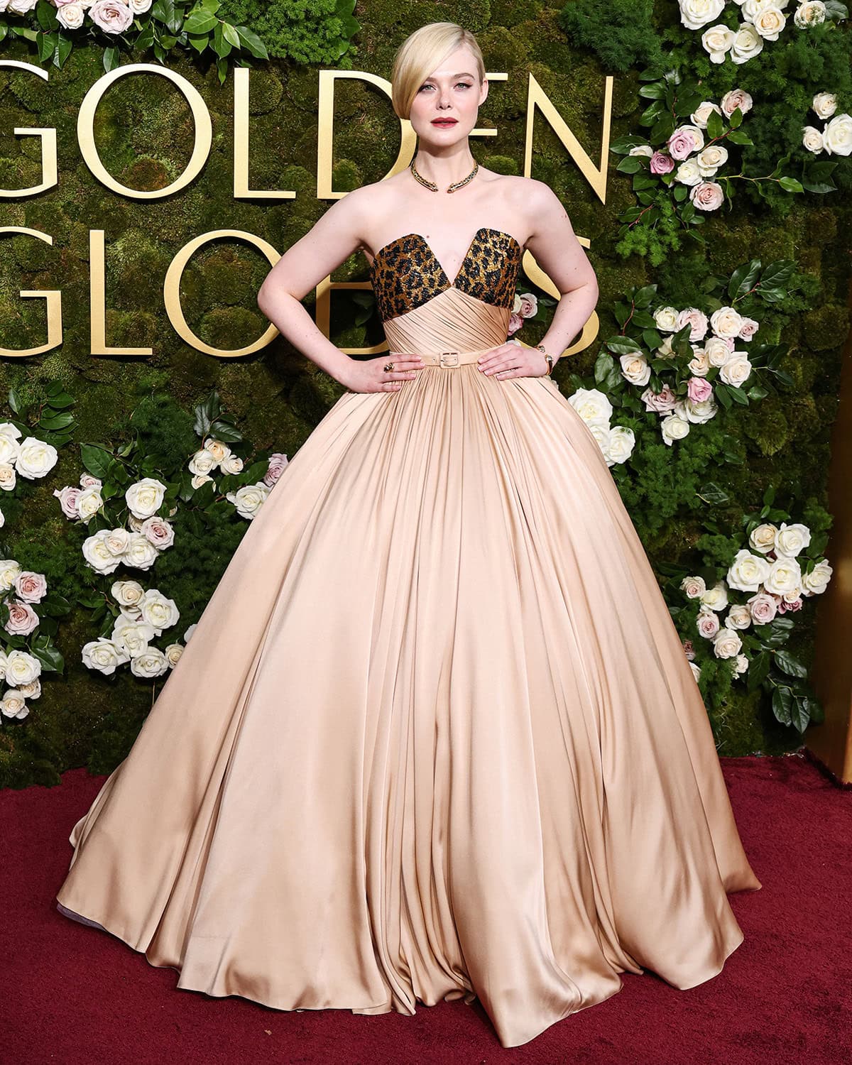 Elle Fanning stuns in a 1950s-style Balmain gown featuring a sequined leopard neckline and a full ball gown skirt at the 82nd Annual Golden Globe Awards