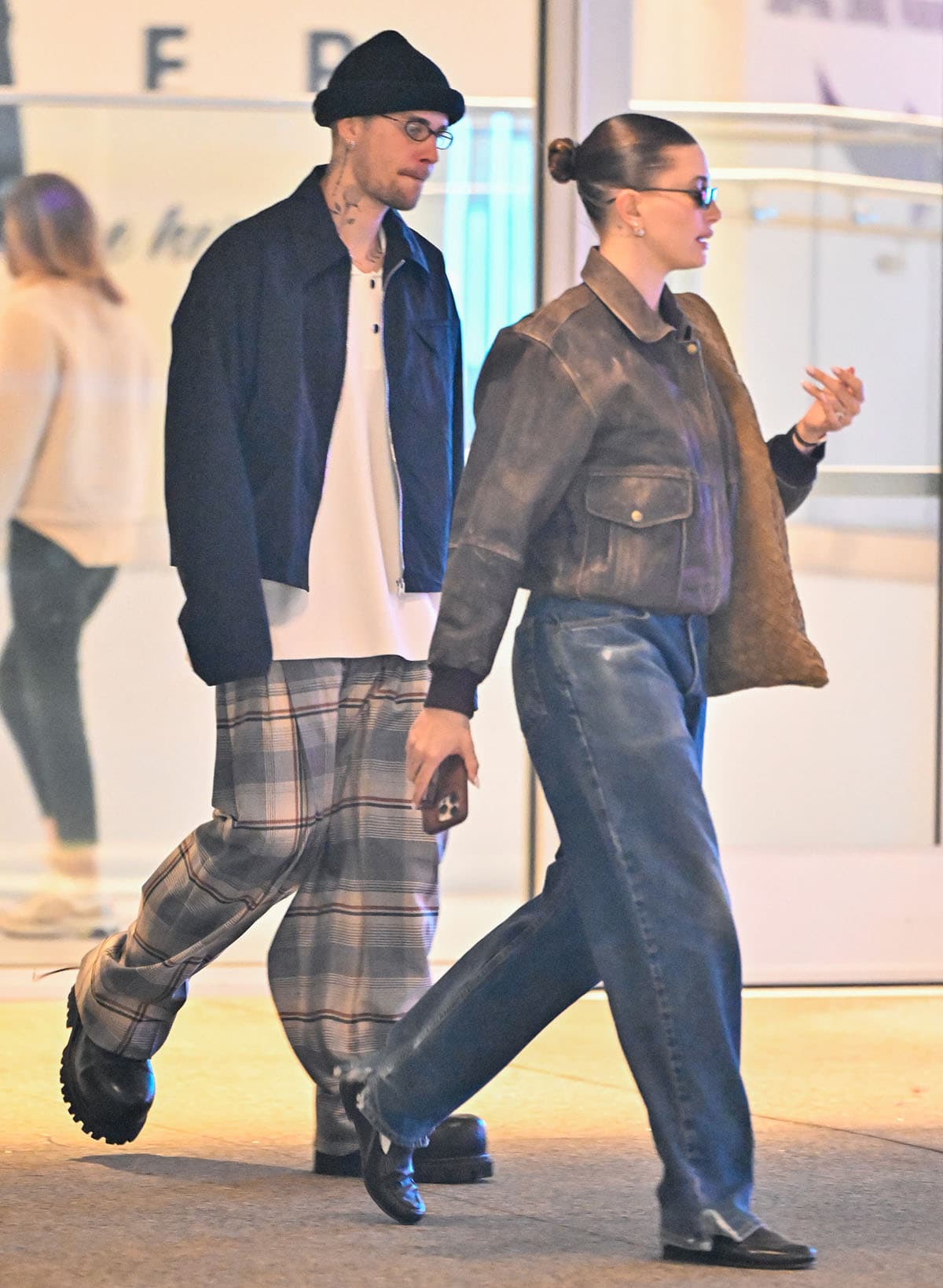 Hailey Bieber wears the same The Row Canal loafers but with a distressed leather jacket and a hobo bag