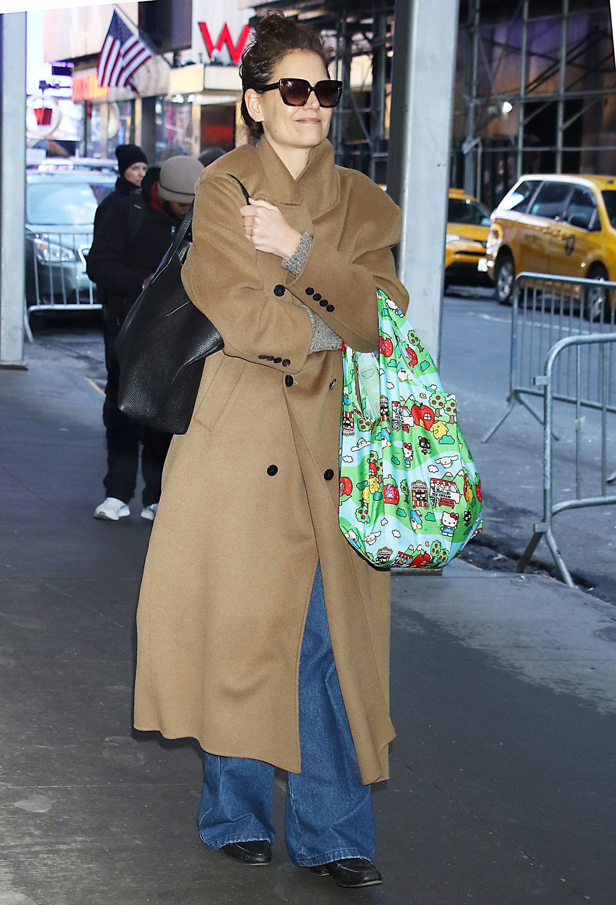 Katie Holmes looks cozy in The Frankie Shop Gaia camel coat, knitted sweater, and loose-fitting jeans