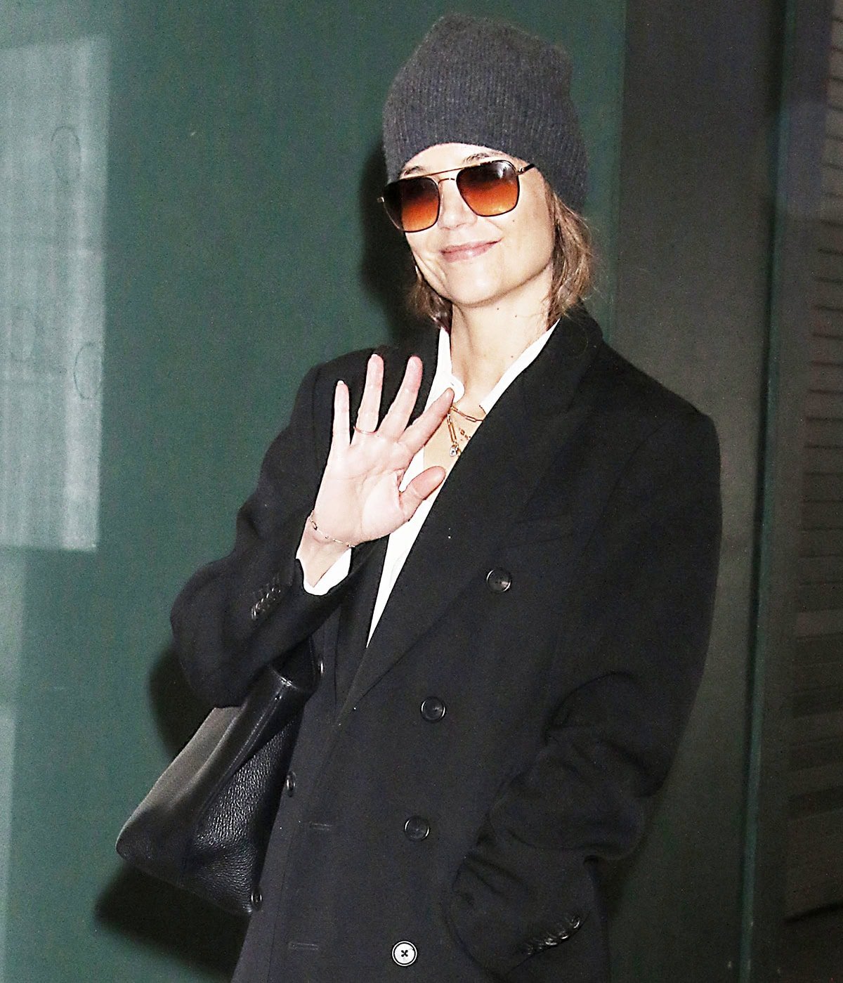 Katie Holmes keeps things cozy with a gray beanie and styles her chic laid-back look with ombre sunglasses and a black Mansur Gavriel tote bag