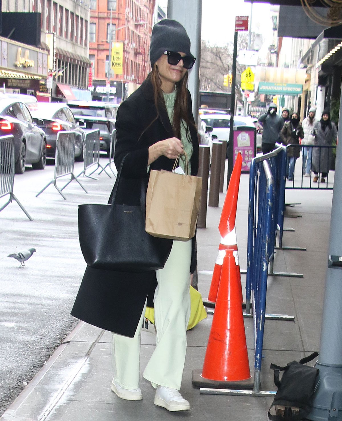 Katie Holmes wears a springtime mint green pastel sweater with lighter mint green pants as she arrives at the Barrymore Theatre for her performance of Thornton Wilder's Our Town