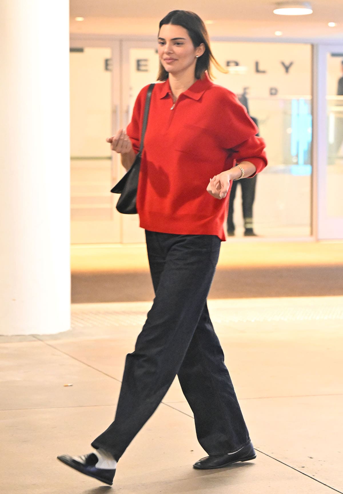 Kendall Jenner steps out on a date with couple Justin and Hailey Bieber in a red The Row cashmere sweater, baggy jeans, and The Row Canal loafers