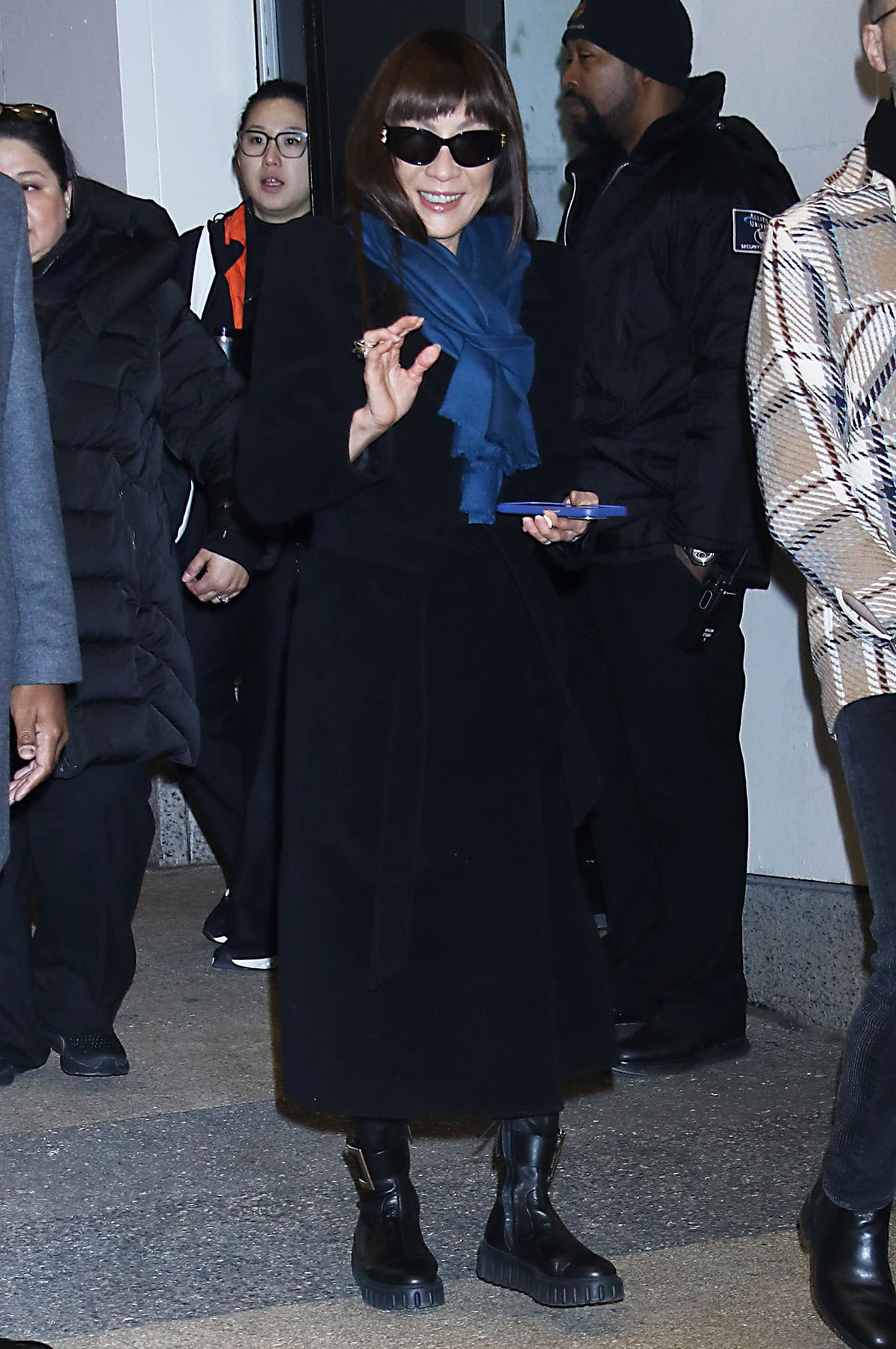 Michelle Yeoh looks cozy and chic in a black Balenciaga cashmere wool blend coat with a waist tie and a blue scarf outside the CBS Mornings studio