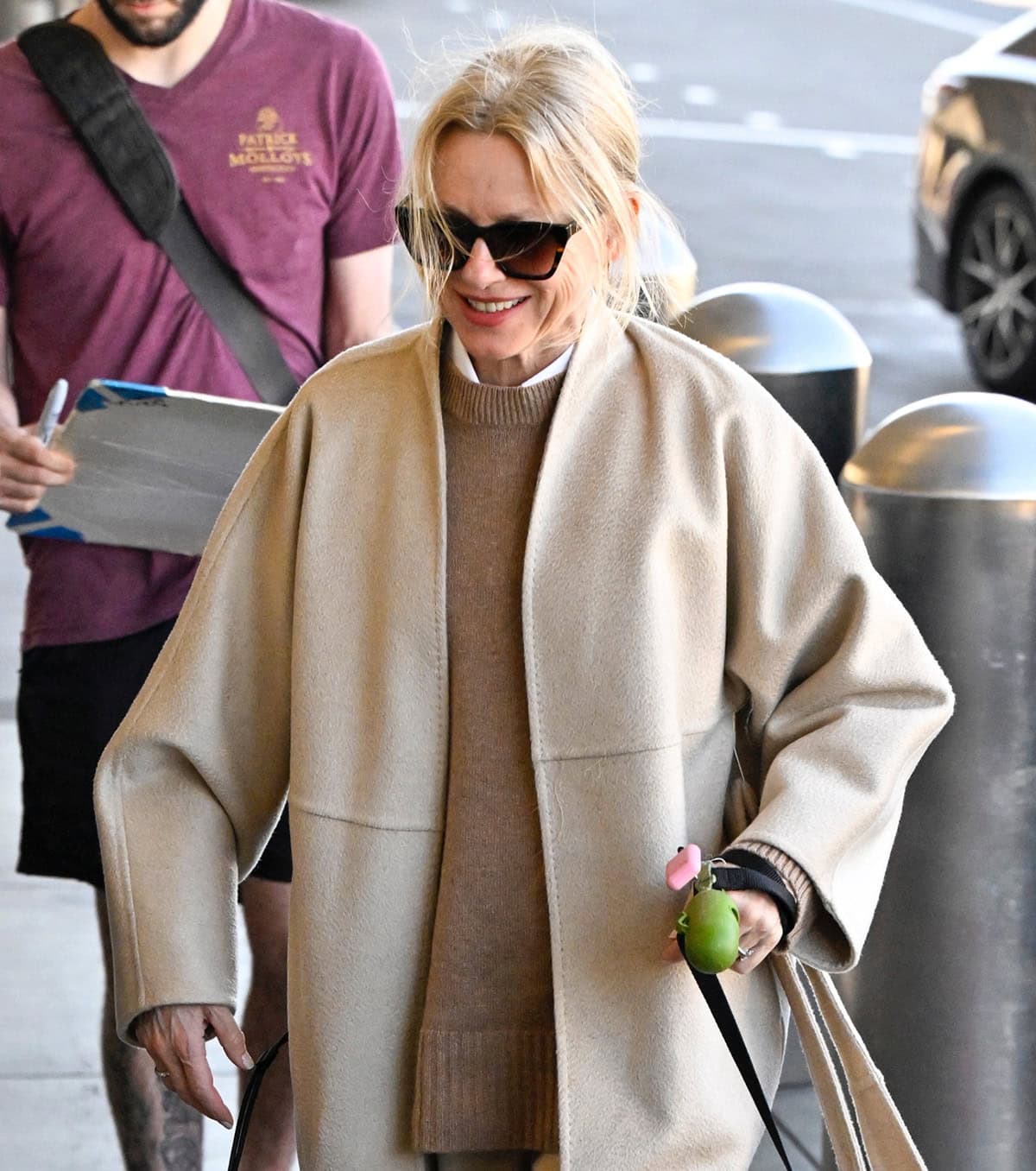 Naomi Watts styles her blonde hair in a messy ponytail and wears minimal makeup with tortoiseshell sunnies adding an enigmatic touch to the look