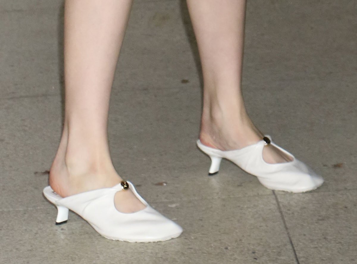 nya Taylor-Joy gives her unusual layered look a hint of feminine glamour with white kitten-heeled mules featuring a cutout vamp