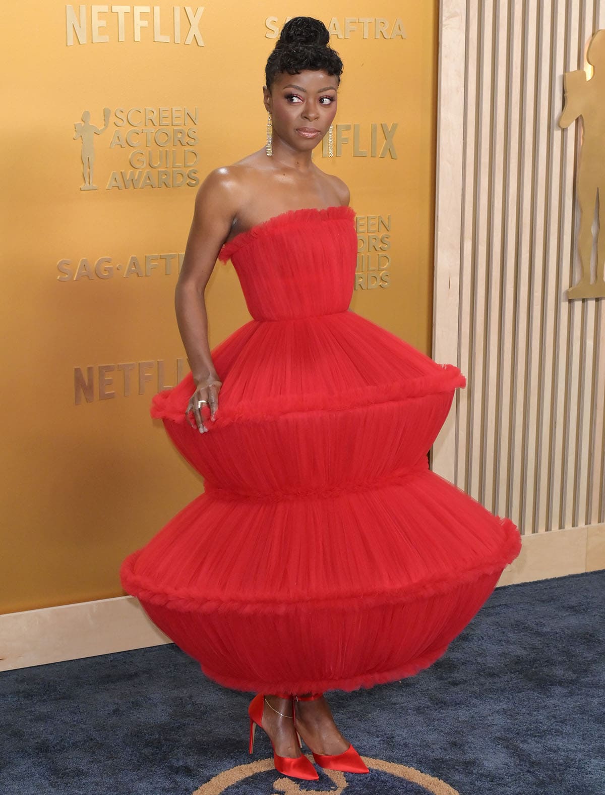 Danielle Deadwyler creates a fiery, cohesive look, teaming her red pumps with an architectural Louis Vuitton gown made of hand-gathered tulle