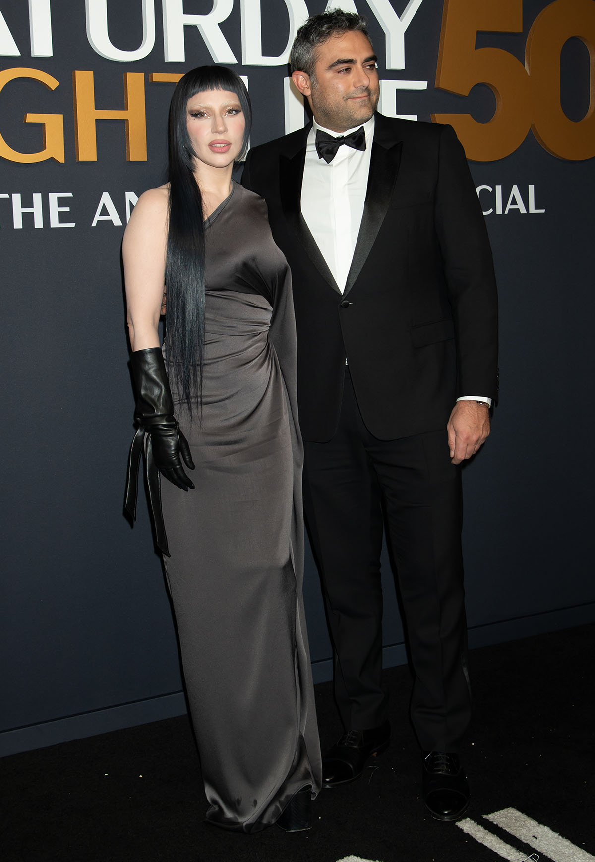 Lady Gaga, with her fiancé Michael Polansky, channels rebellious chic in an Atlein one-shoulder ruched dress