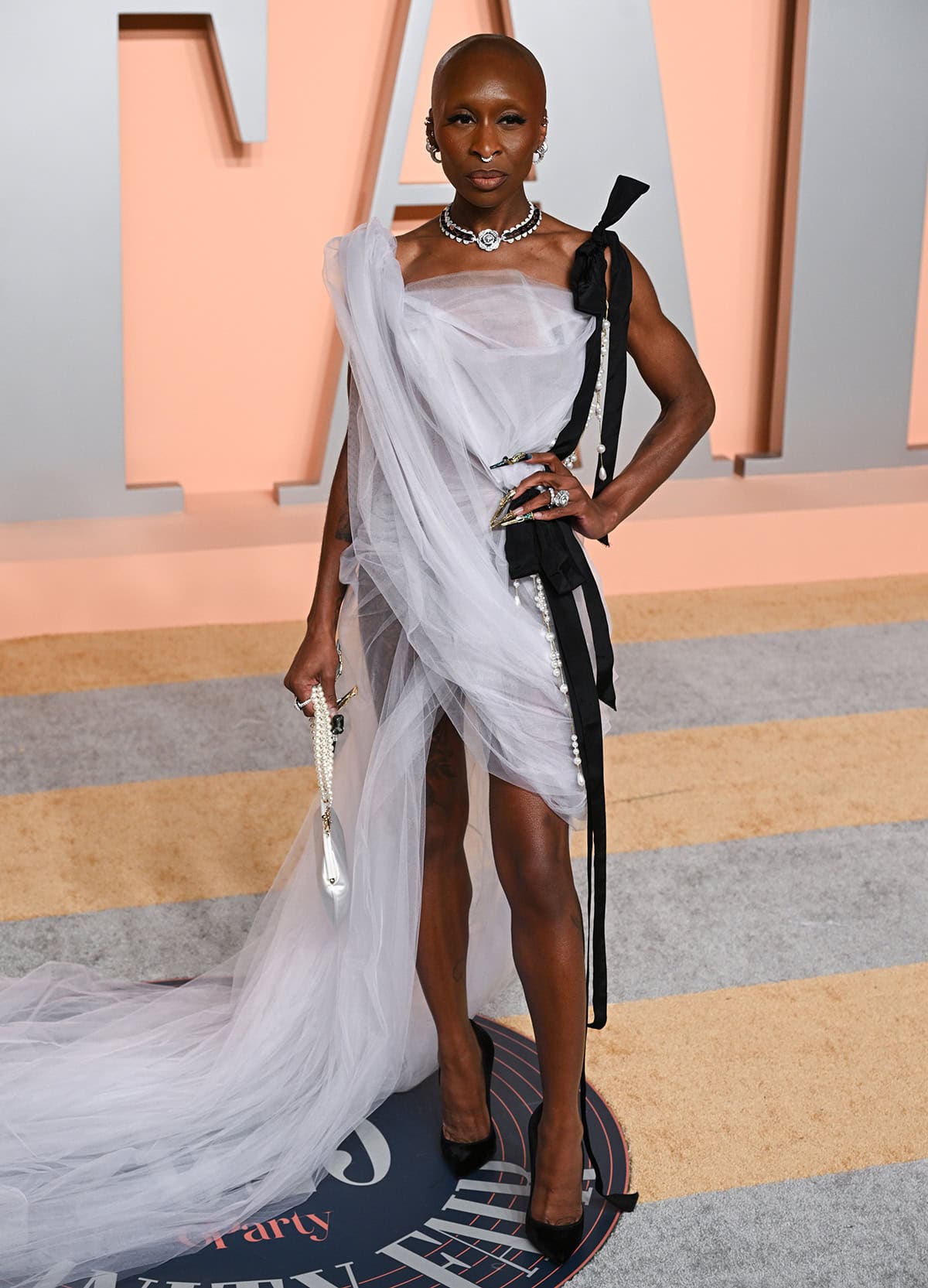 Cynthia Erivo teams her black pumps with a white tulle draped dress by Vivienne Westwood