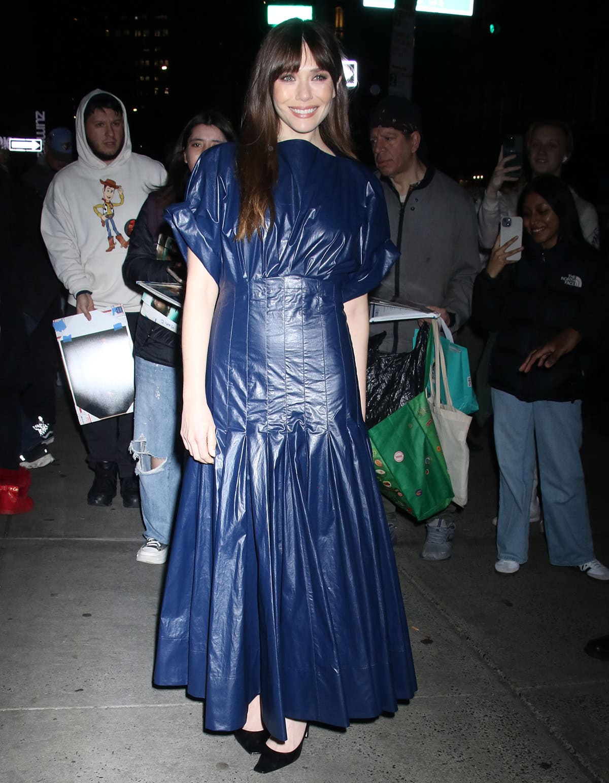 Elizabeth Olsen fails to wow in a navy PVC dress as she attends a Q&A screening for her latest sci-fi thriller, The Assessment