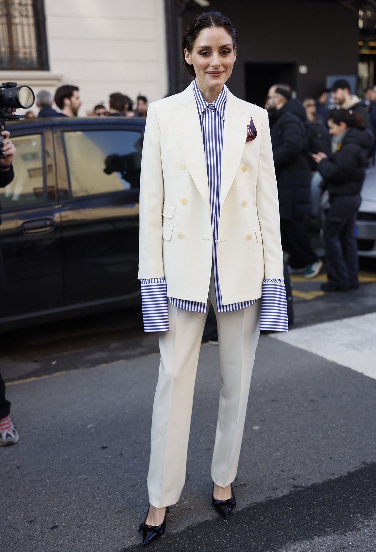 Olivia Palermo teams her Casadei bow-adorned slingback pumps with a white Max Mara wool and mohair suit with an oversized pinstriped shirt underneath